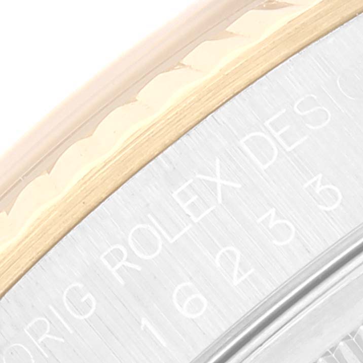This close-up image of the Rolex Datejust 16233 Men's Steel and Gold (two tone) Champagne Dial 16233 Men's Steel and Gold (two tone) Champagne Dial shows part of its bezel and engraved text on the case.
