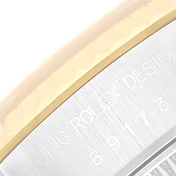 This image shows a close-up of the bezel and part of the case with inscriptions on a Rolex Datejust 69173 Women's Steel and Gold (two tone) Beige Dial 69173 Women's Steel and Gold (two tone) Beige Dial watch.