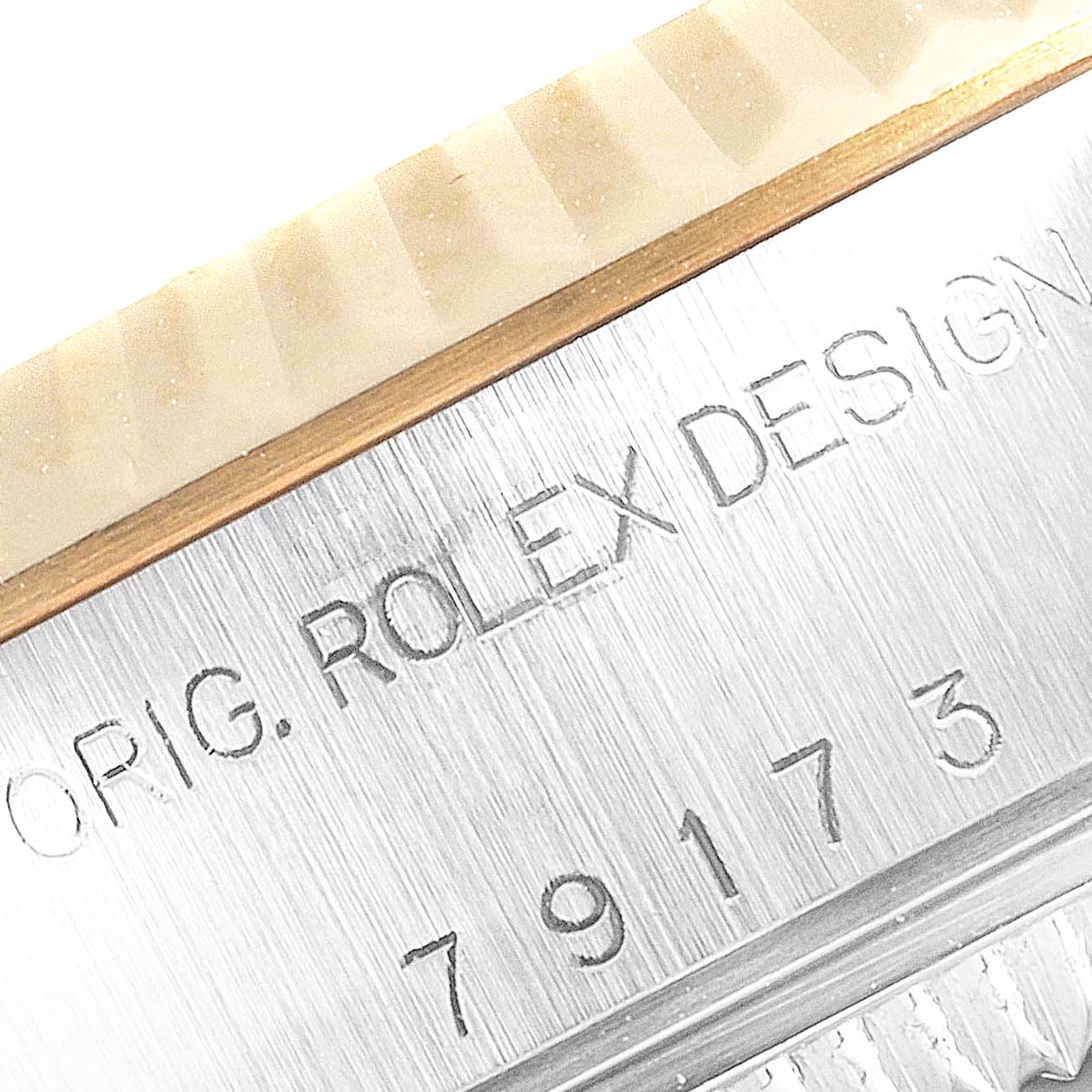 This close-up shows the inscription and part of the bezel on a Rolex Datejust 79173 Women's Steel and Gold (two tone) Silver Dial 79173 Women's Steel and Gold (two tone) Silver Dial watch.