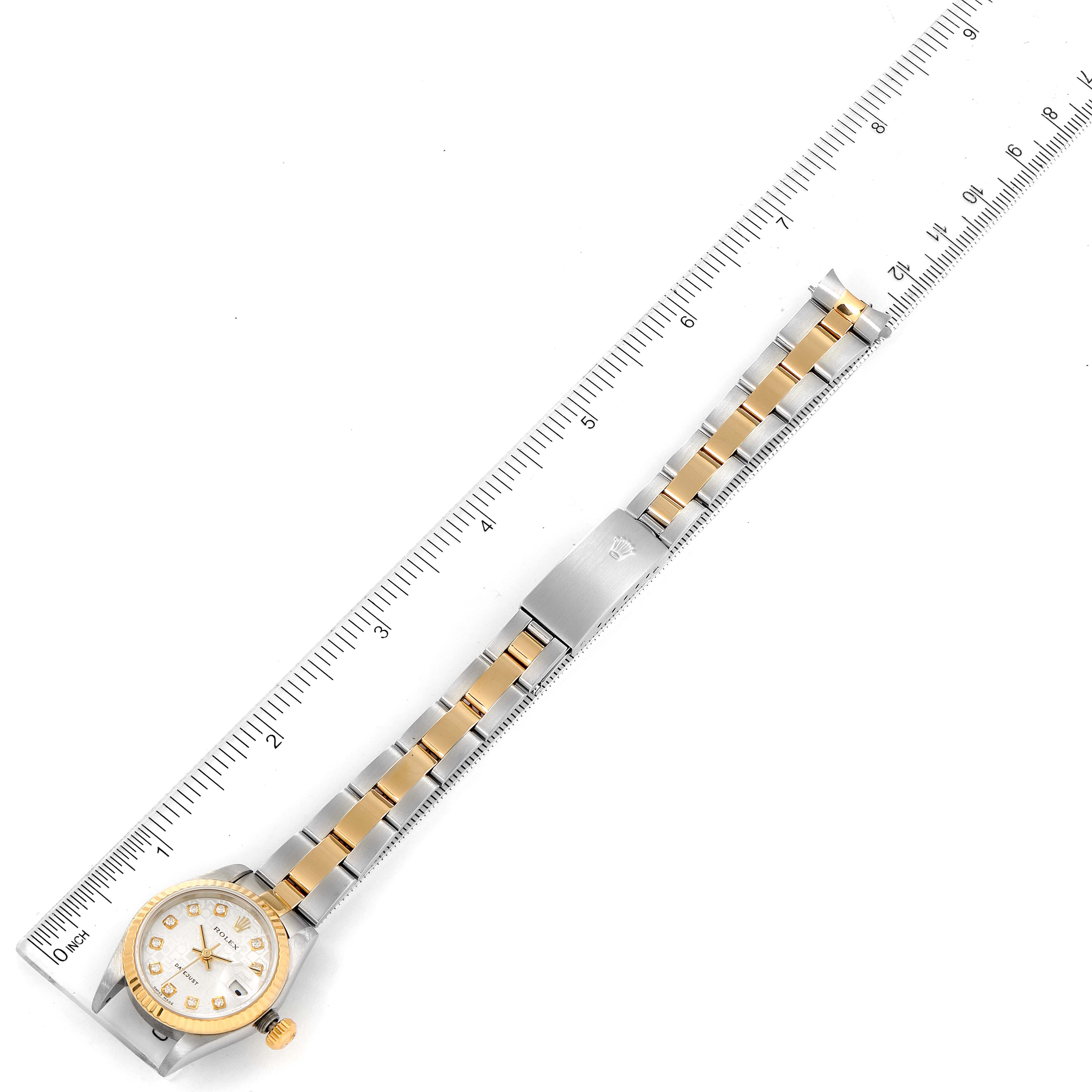 This image shows the length of a Rolex Datejust 79173 Women's Steel and Gold (two tone) Silver Dial 79173 Women's Steel and Gold (two tone) Silver Dial watch alongside a ruler, displaying the dial and bracelet.