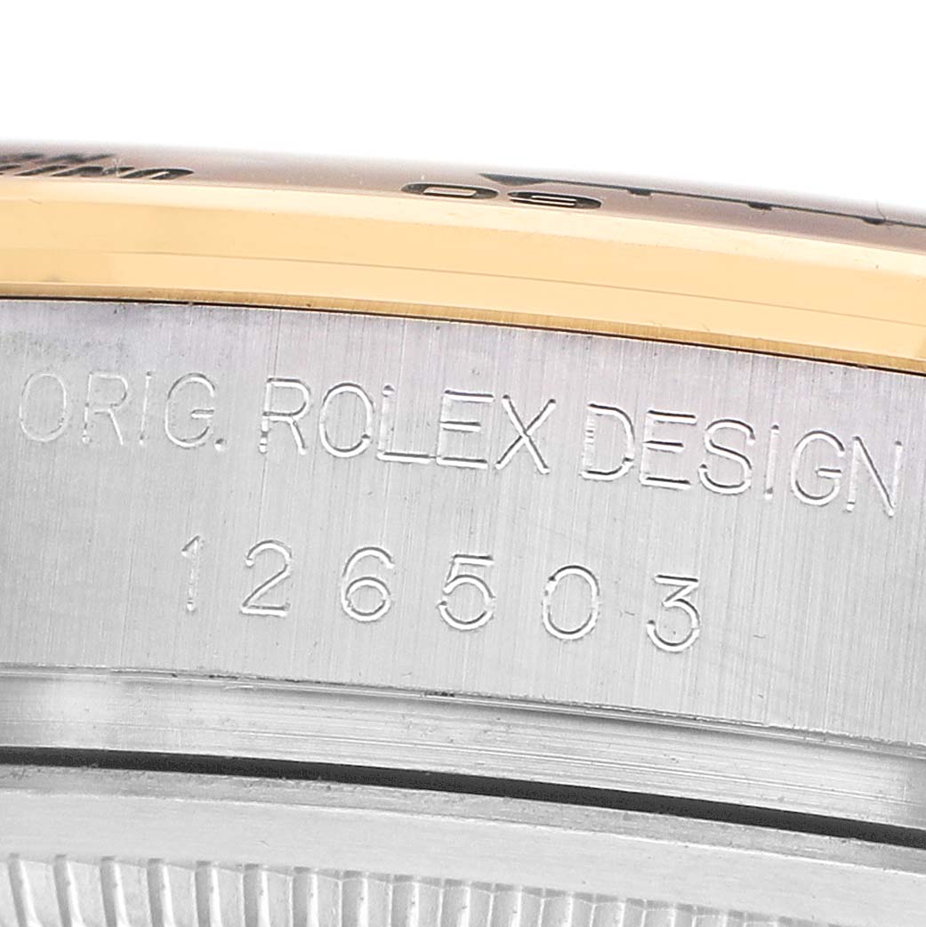 The image shows a close-up of the side of a Rolex Daytona 126503 Men's Steel and Gold (two tone) Black Dial watch case, highlighting the engraved model number and design engraving.
