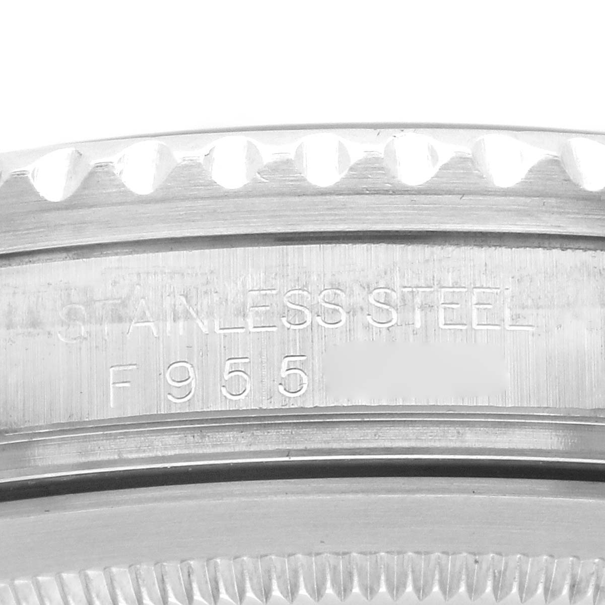 The image shows a close-up view of the side of a Rolex GMT-Master 16710 Men's Stainless Steel Black Dial 16710 Men's Stainless Steel Black Dial, highlighting the stainless steel and part of the serial number.