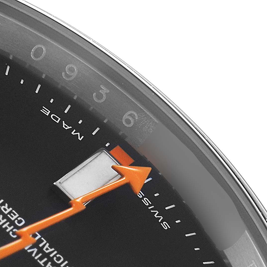 Close-up view of the Rolex Milgauss 116400 Men's Stainless Steel Black Dial 116400 Men's Stainless Steel Black Dial watch, showing part of the dial, the orange lightning bolt second hand, and the hour markers.