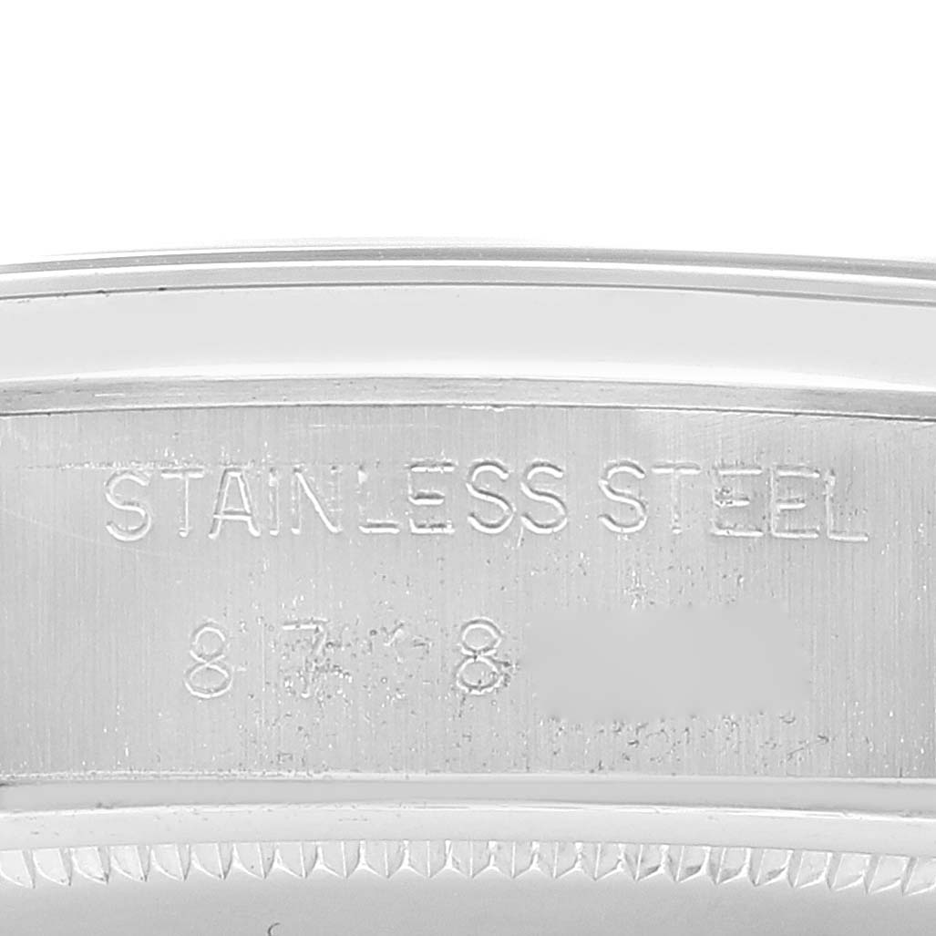 This close-up image shows the engraved "STAINLESS STEEL" marking and part of the serial number on a Rolex Date 6694 Men's Stainless Steel Silver Dial 6694 Men's Stainless Steel Silver Dial model watch case.