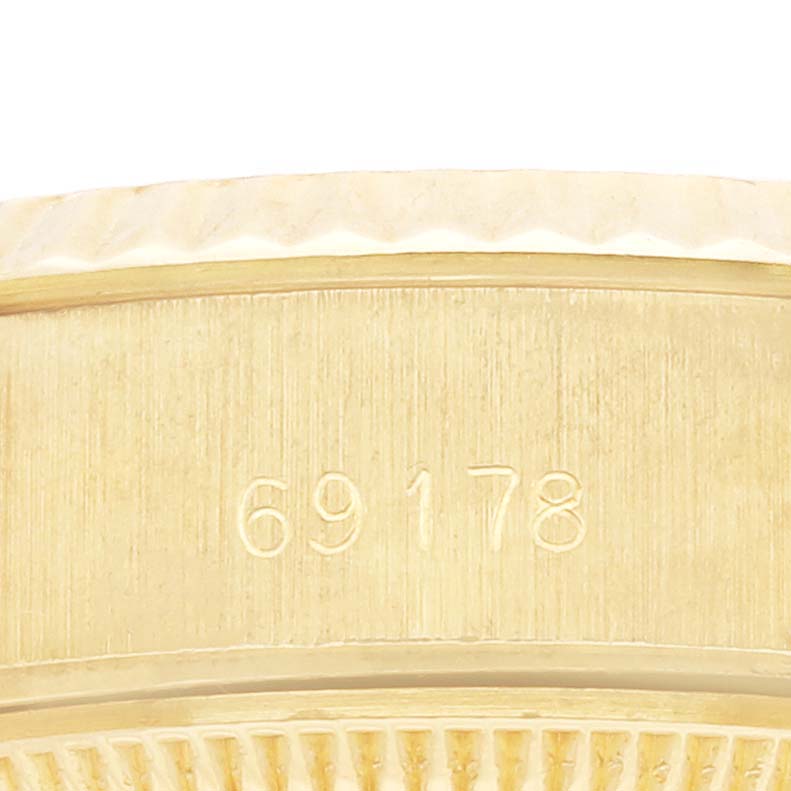 The image shows a close-up view of the case side of a Rolex President 69178 Women's Yellow Gold White Dial 69178 Women's Yellow Gold White Dial model, featuring its engraved serial number.