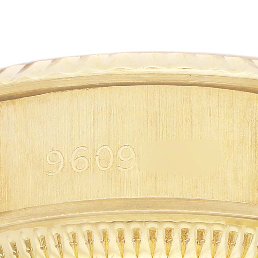 The image shows a close-up of the side of a Rolex Datejust 69178 Women's Yellow Gold Champagne Dial model, highlighting the serial number engraving.