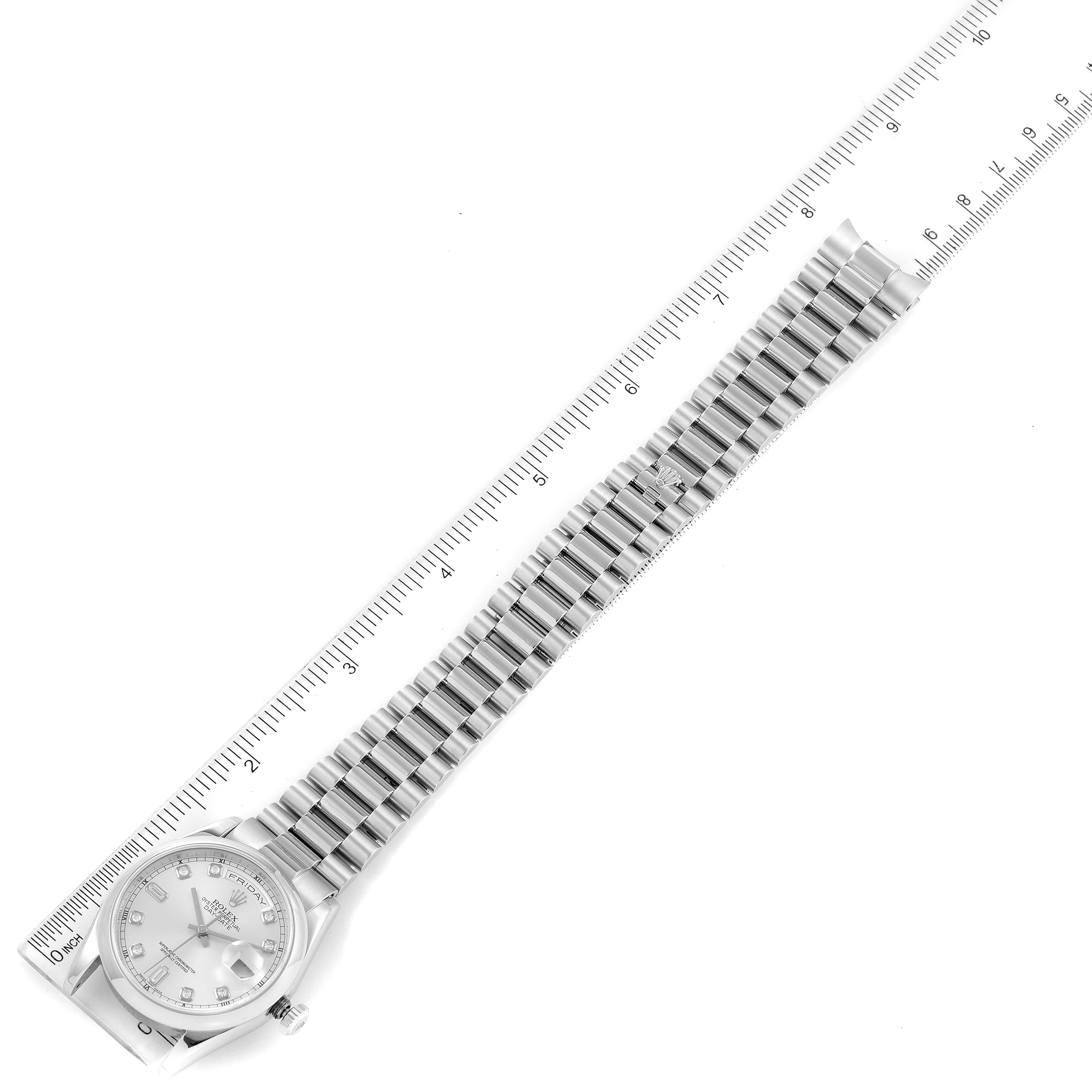 The image shows a top view of the Rolex President 118206 Men's Platinum Silver Dial 118206 Men's Platinum Silver Dial model watch, displaying its face and full bracelet alongside a measuring ruler.