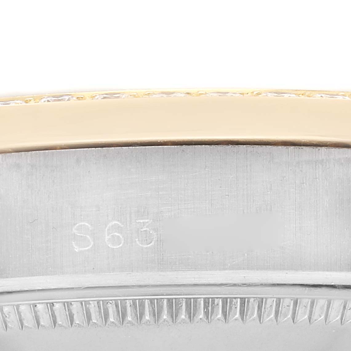 This close-up image shows the serial number engraving on the side of the case of a Rolex President 68289 Women
s Steel and Gold (two tone) Mother of Pearl Dial 68289 Women
s Steel and Gold (two tone) Mother of Pearl Dial model.