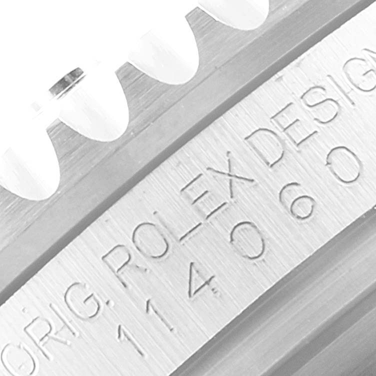 The image is a close-up showing the bezel edge and engraved inner rim design of a Rolex Submariner 114060 Men
s Stainless Steel Black Dial 114060 Men
s Stainless Steel Black Dial watch.