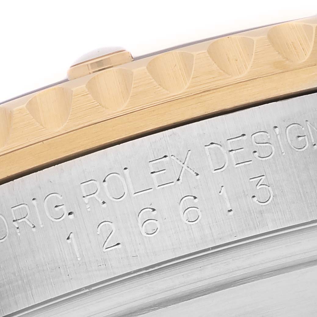 This close-up image of the Rolex Submariner 126613LB Men's Steel and Gold (two tone) Blue Dial 126613LB Men's Steel and Gold (two tone) Blue Dial shows the engraved reference number on the case and part of the gold-edged bezel.