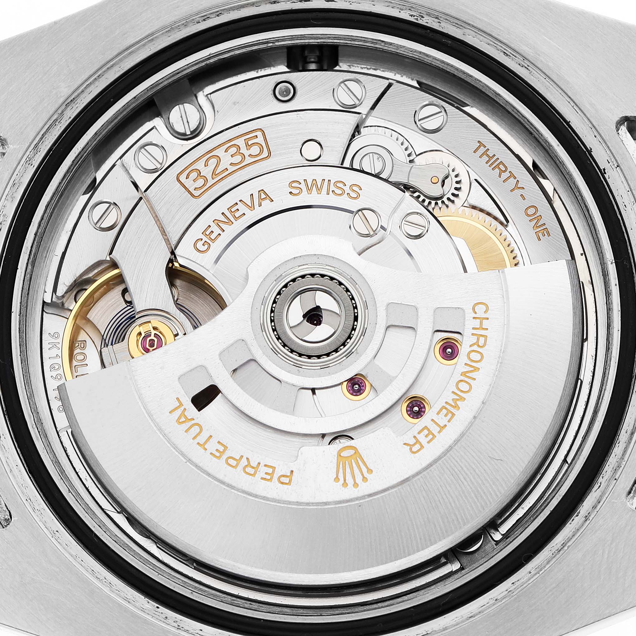 The image shows a close-up of the Rolex Submariner 126610LN Men's Stainless Steel Black Dial's movement from the back, featuring the rotor and intricate components.