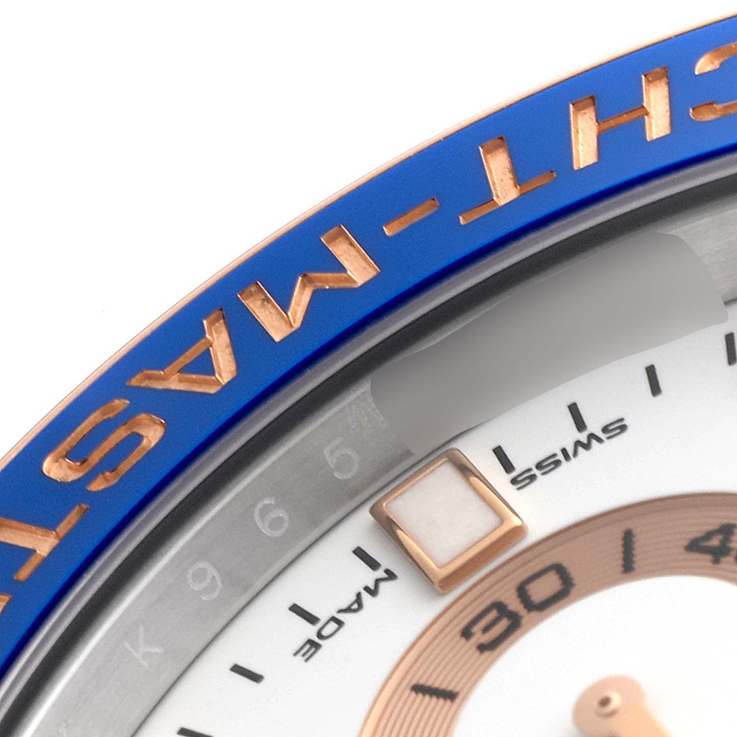 This image shows a close-up of the bezel and part of the dial of a Rolex Yacht-Master 116681 Men
s Steel and Gold (two tone) White Dial 116681 Men
s Steel and Gold (two tone) White Dial watch.