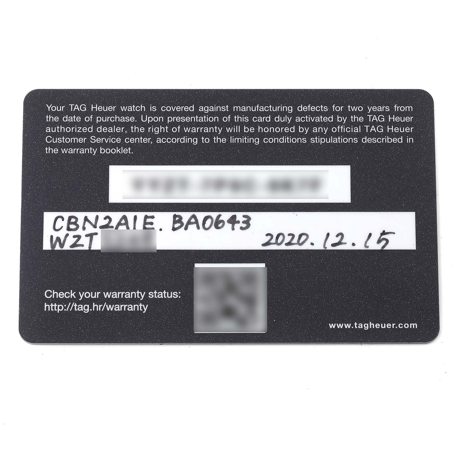 This is a close-up of a Tag Heuer Carrera CBN2A1E.BA0643 Men's Stainless Steel Blue Dial CBN2A1E.BA0643 Men's Stainless Steel Blue Dial model warranty card showing the warranty terms and serial number.