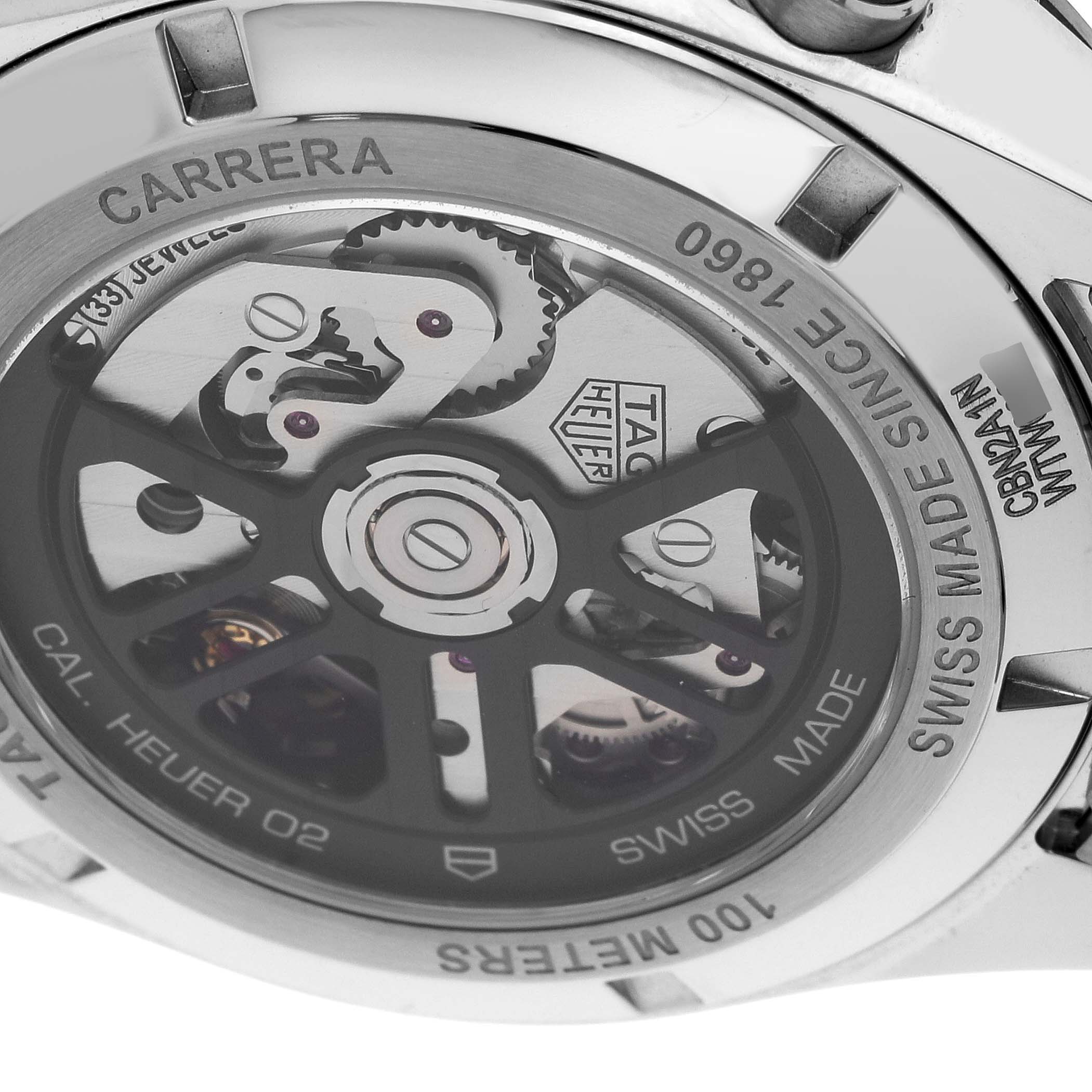 The image shows the back of the Tag Heuer Carrera CBN2A1N.BA0643 Men's Stainless Steel Green Dial CBN2A1N.BA0643 Men's Stainless Steel Green Dial watch, highlighting its internal mechanical movement and engravings.