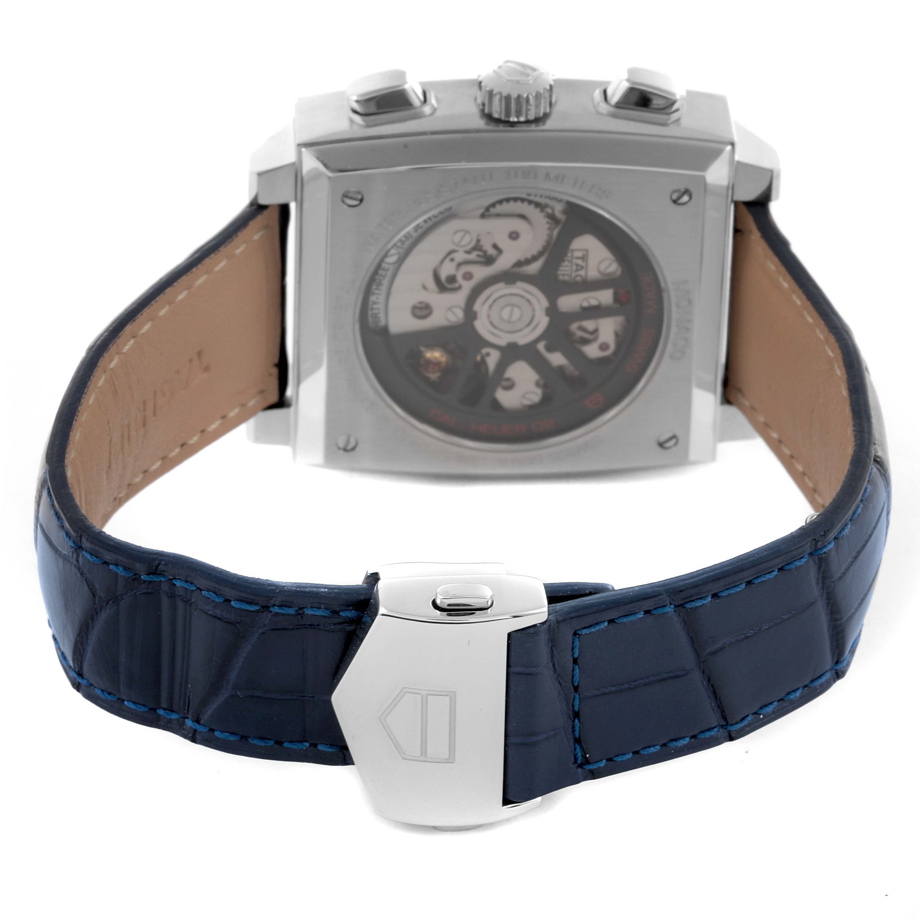 The image shows the back of a Tag Heuer Monaco CBL2111.FC6453 Men's Stainless Steel Blue Dial CBL2111.FC6453 Men's Stainless Steel Blue Dial watch, highlighting the movement and blue leather strap with a clasp.