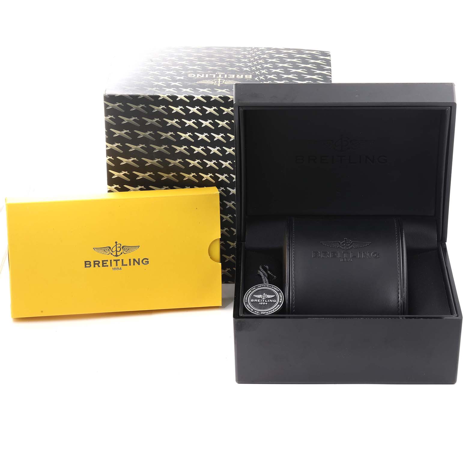 The image shows a Breitling Chronoliner Y24310 Men's Stainless Steel Brown Dial Y24310 Men's Stainless Steel Brown Dial watch's packaging, including a box, leather case, and a yellow warranty booklet.