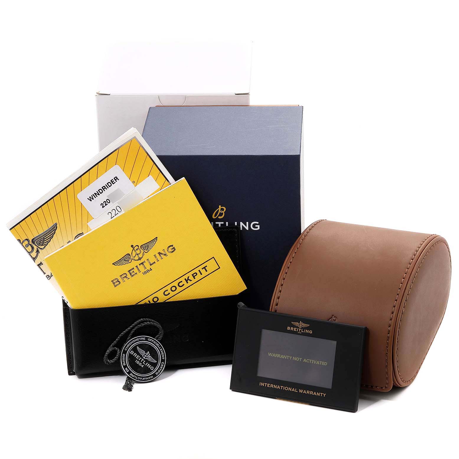 The image shows the packaging and documents for the Breitling Windrider K13358 Men's Yellow Gold Mother of Pearl Dial K13358 Men's Yellow Gold Mother of Pearl Dial, including a box, instructions, warranty card, and a leather case.