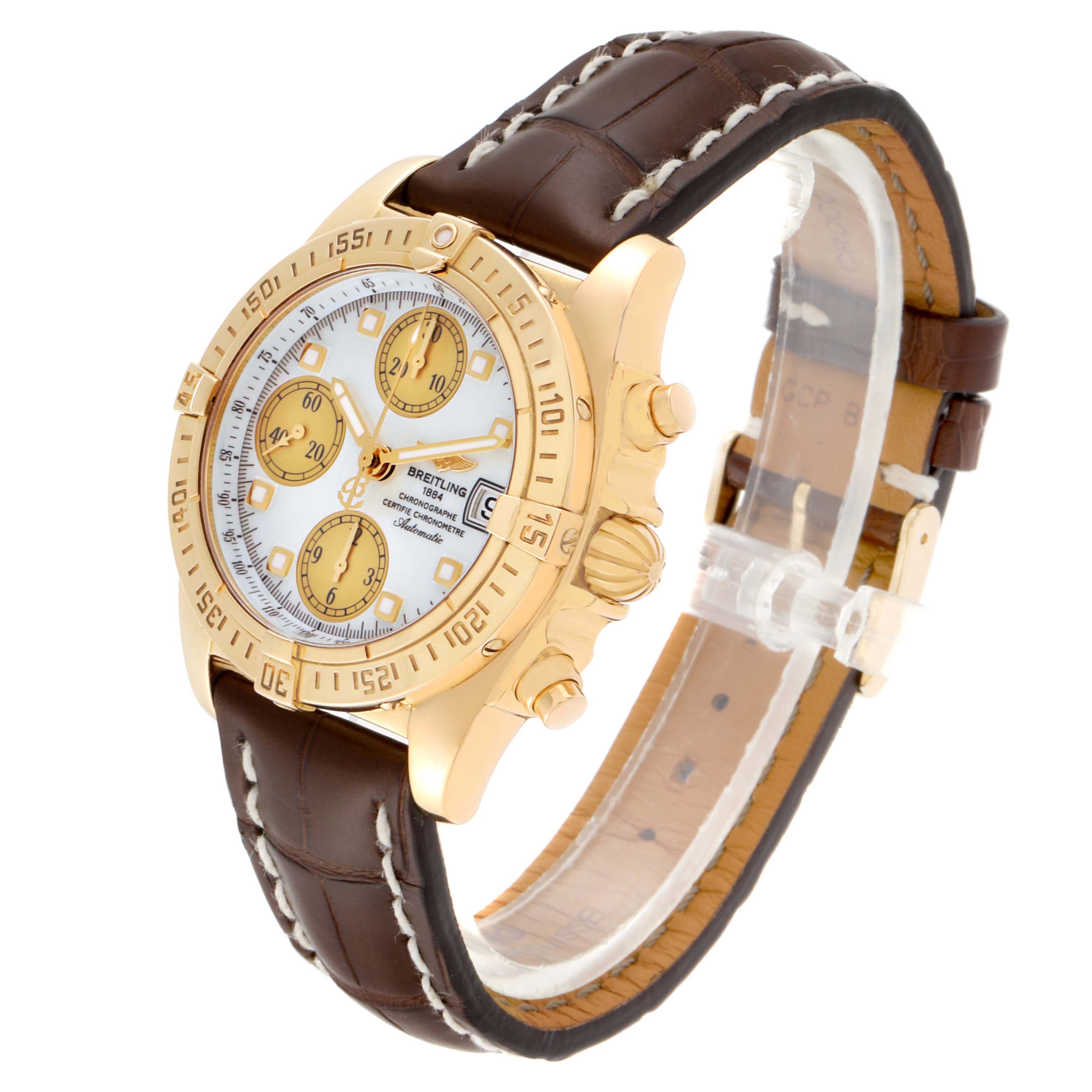 The Breitling Windrider K13358 Men's Yellow Gold Mother of Pearl Dial K13358 Men's Yellow Gold Mother of Pearl Dial watch is shown at a three-quarter angle, displaying the face, bezel, crown, pushers, and leather strap.