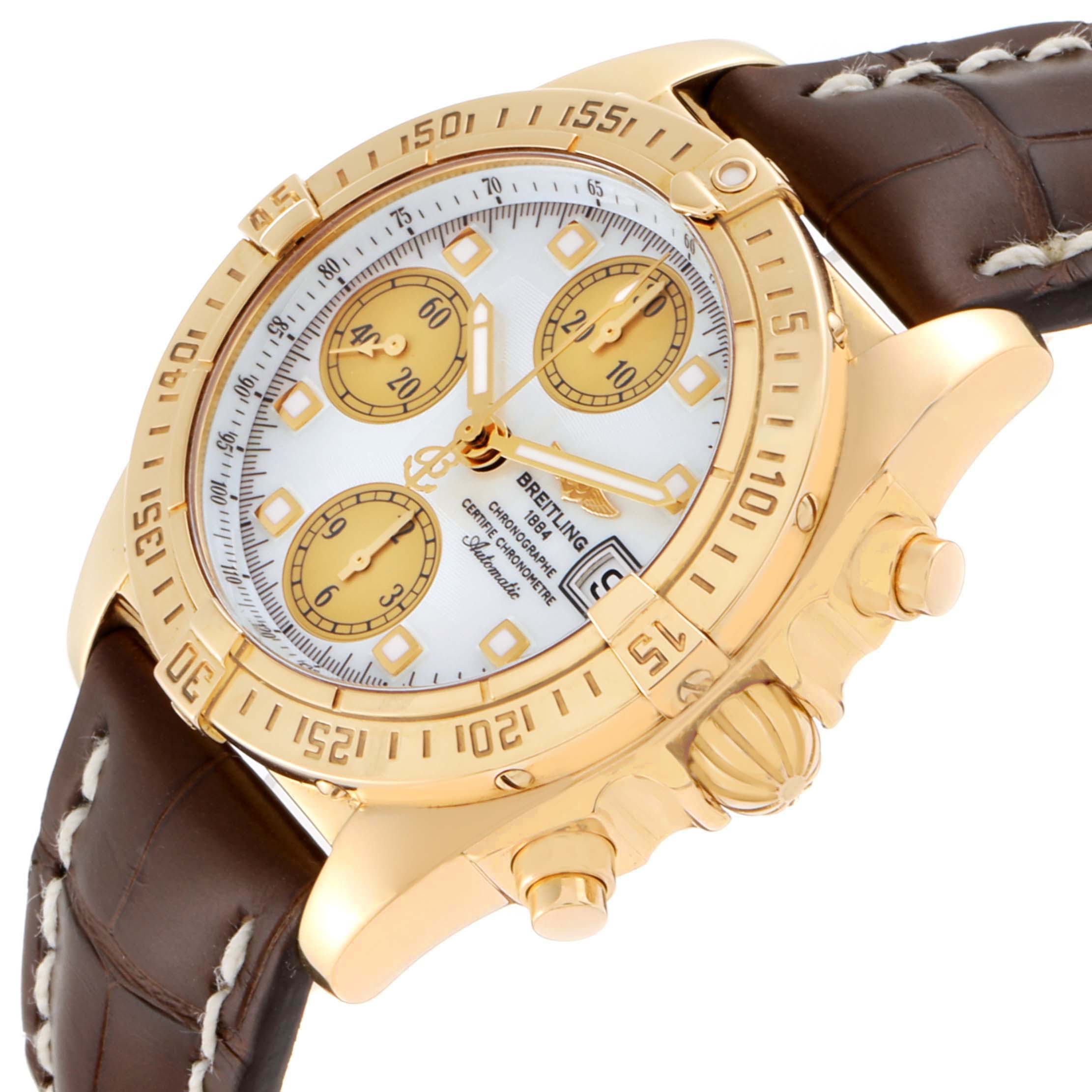 This is the Breitling Windrider K13358 Men's Yellow Gold Mother of Pearl Dial K13358 Men's Yellow Gold Mother of Pearl Dial watch at an angled view, showing the face, bezel, pushers, crown, and leather strap.