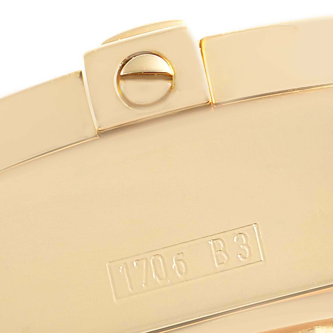 This image shows a close-up of the clasp of a Breitling Windrider K13358 Men's Yellow Gold Mother of Pearl Dial K13358 Men's Yellow Gold Mother of Pearl Dial watch, featuring a screw and engraved model detail.