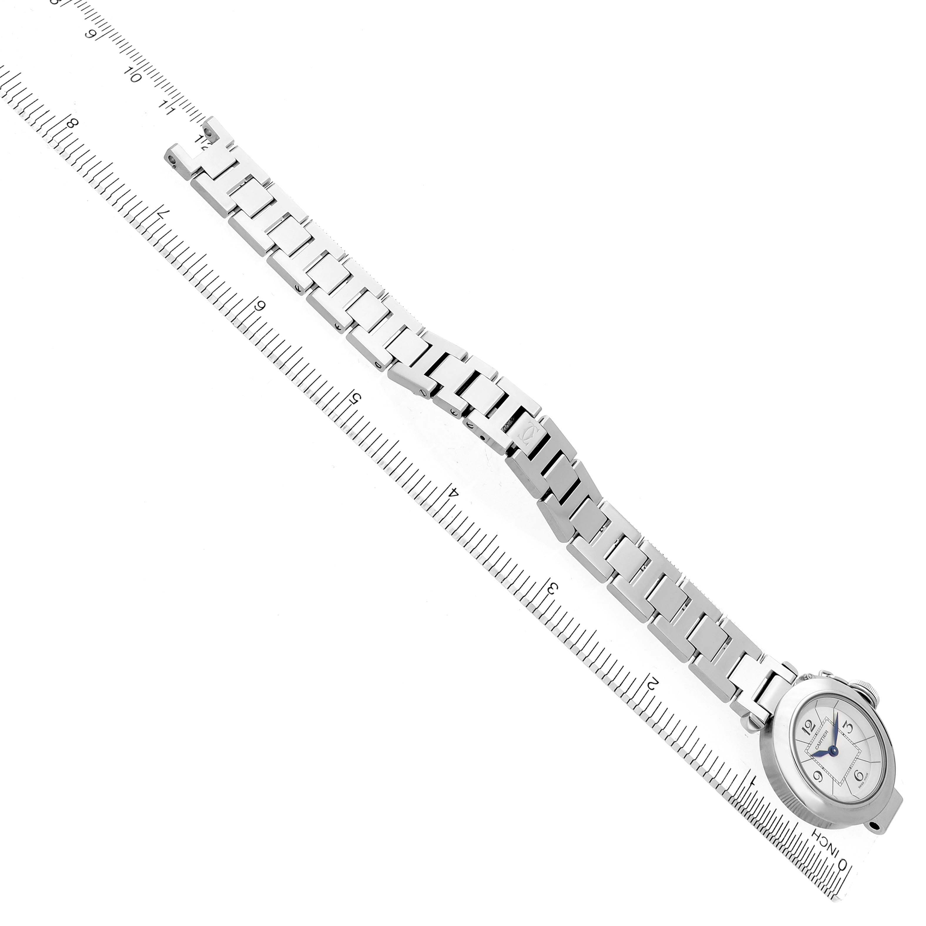 The Cartier Pasha W3140007 Women's Stainless Steel Silver Dial W3140007 Women's Stainless Steel Silver Dial watch is shown at an angled top view, displaying its face and entire metal bracelet alongside a ruler for scale.