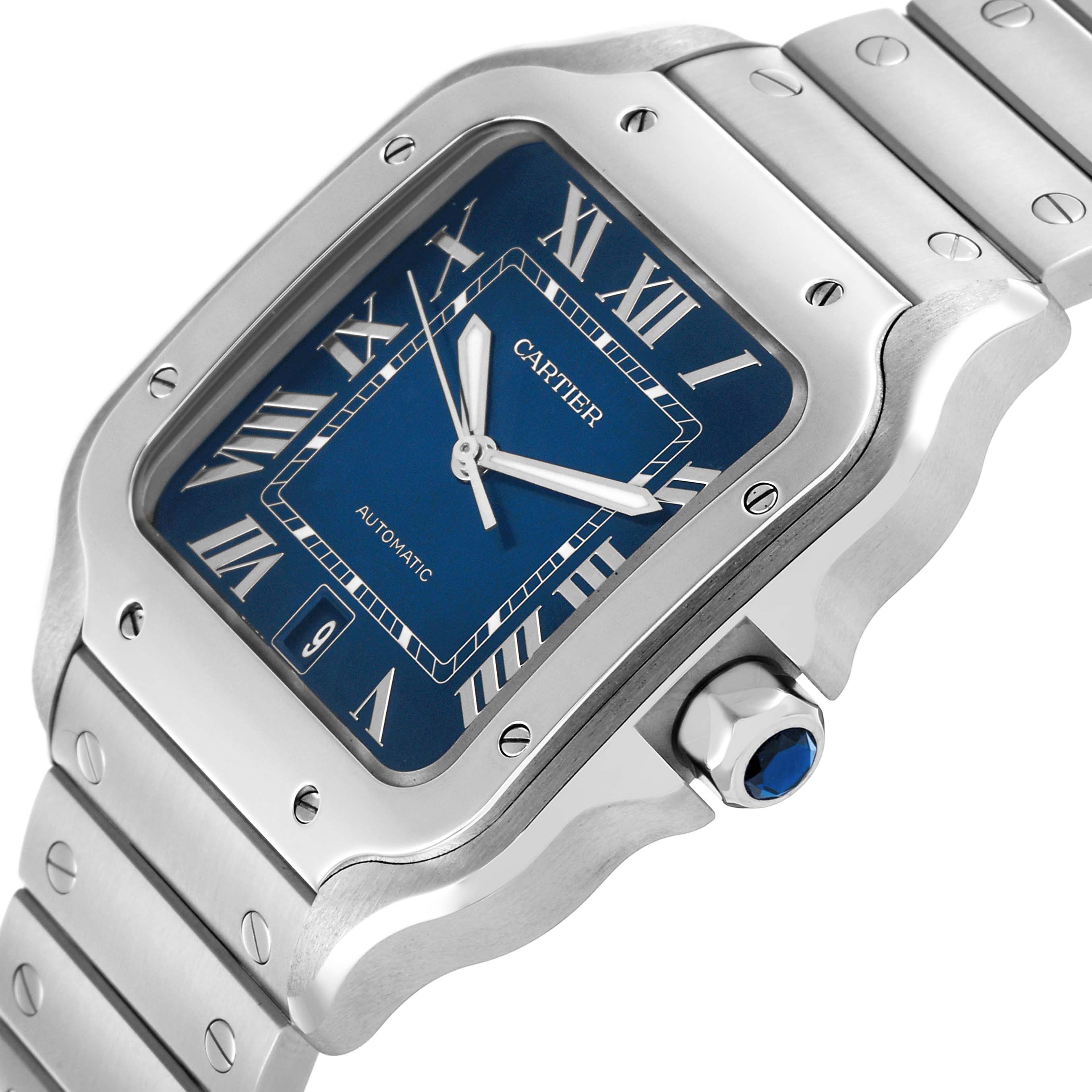 The Cartier Santos WSSA0030 Men's Stainless Steel Blue Dial WSSA0030 Men's Stainless Steel Blue Dial watch is shown at a slight angle, highlighting the face, bezel, crown with a blue stone, and bracelet.