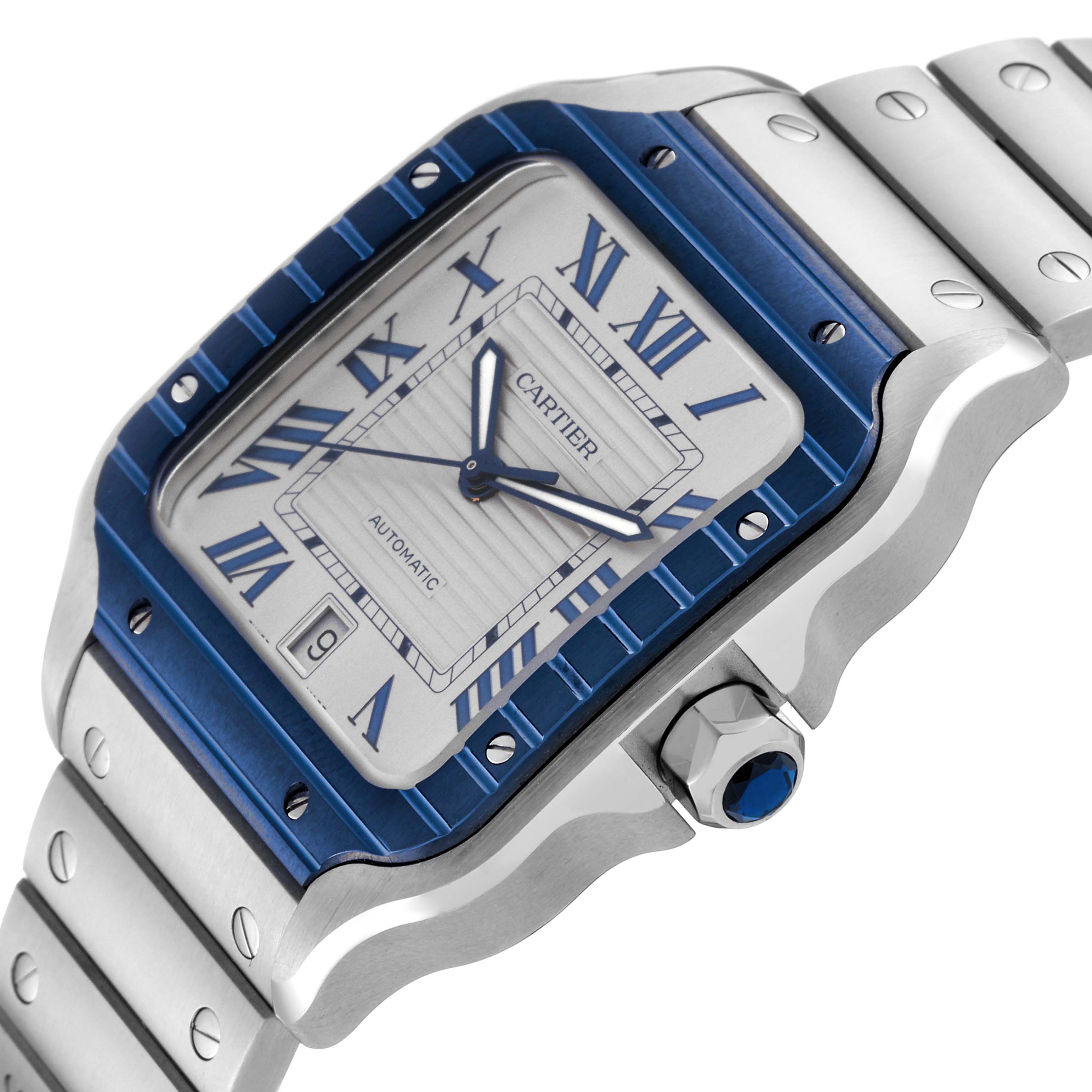 The image shows a close-up, angled view of a Cartier Santos WSSA0047 Men
s Stainless Steel Silver Dial WSSA0047 Men
s Stainless Steel Silver Dial watch, highlighting the dial, bezel, and part of the bracelet.