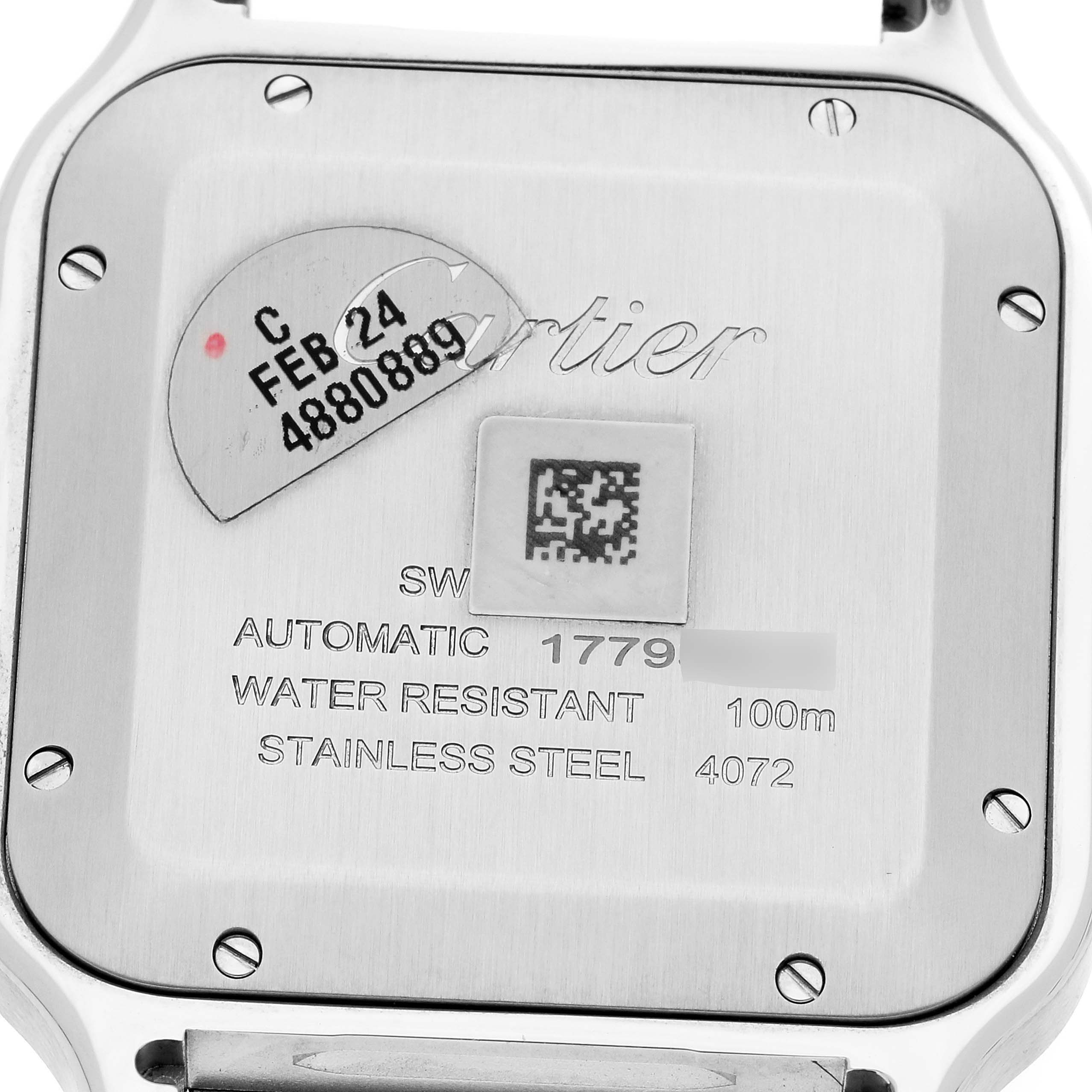 This image shows the back case of a Cartier Santos WSSA0018 Men
s Stainless Steel Silver Dial WSSA0018 Men
s Stainless Steel Silver Dial watch with inscriptions and markings.