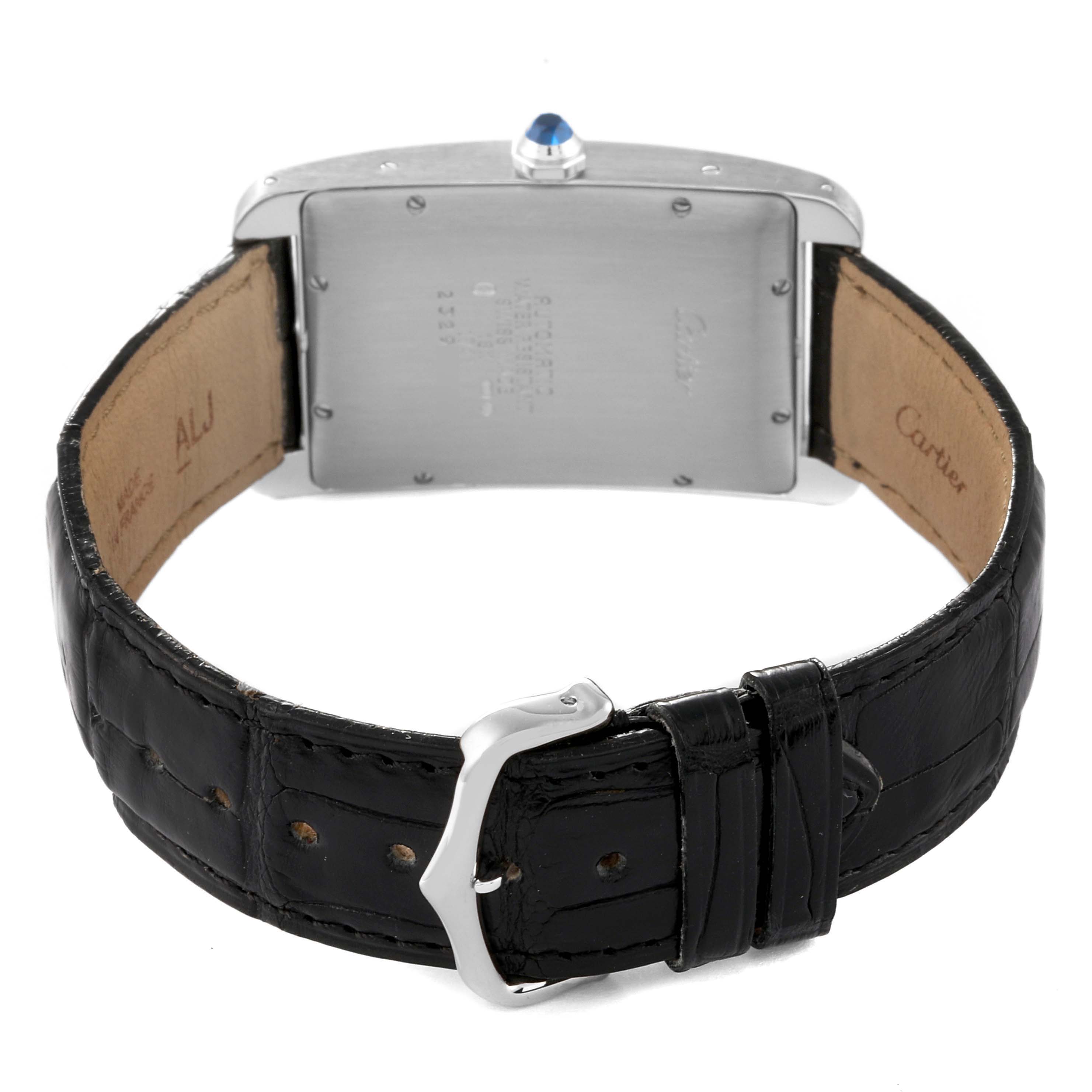 This image shows the back view of the Tank Américaine model by Cartier, displaying the caseback, crown, and leather strap with buckle.