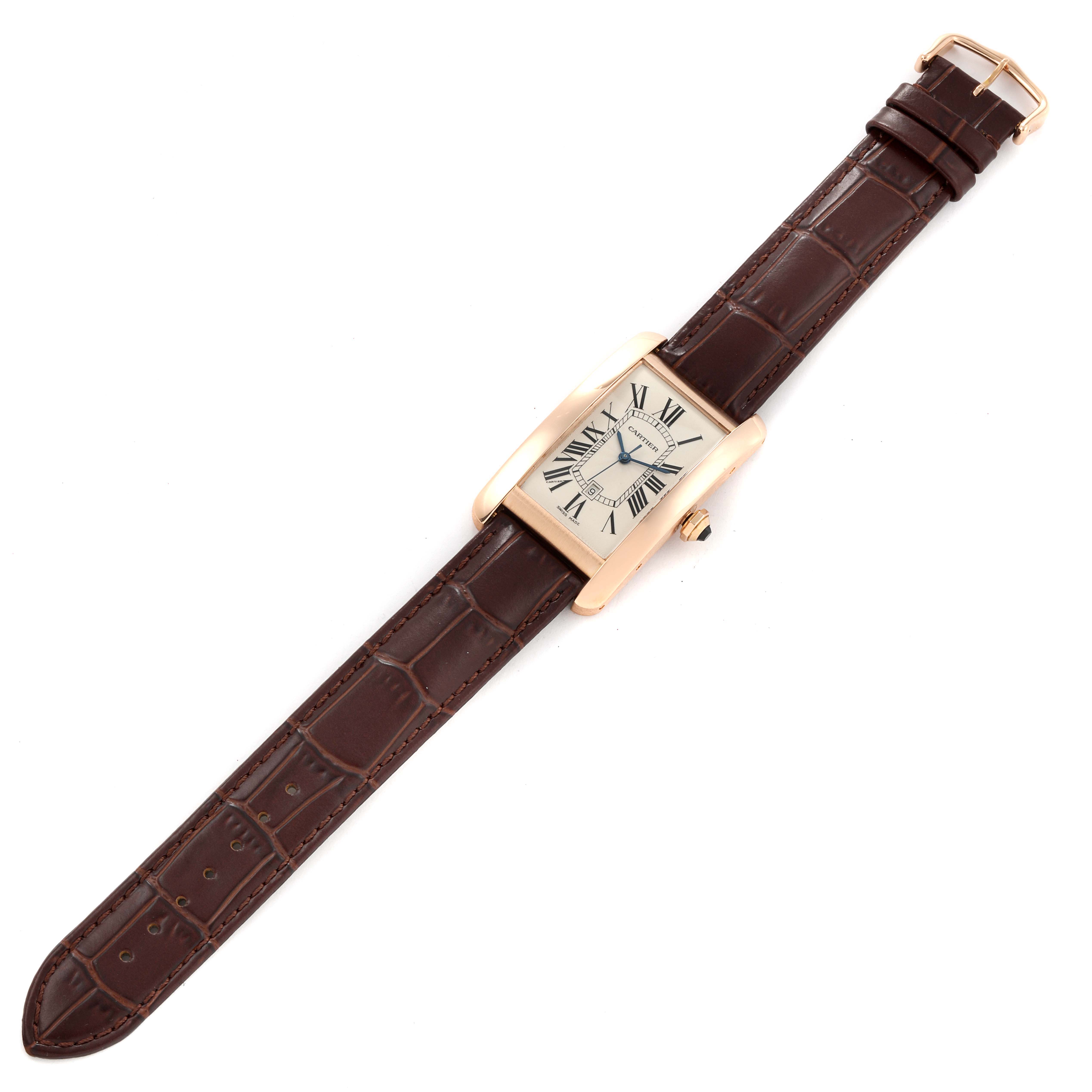 The image shows a top view of the Cartier Tank Americaine W2609156 Men
s Rose Gold Silver Dial W2609156 Men
s Rose Gold Silver Dial watch, highlighting its face, brown leather strap, and gold buckle.