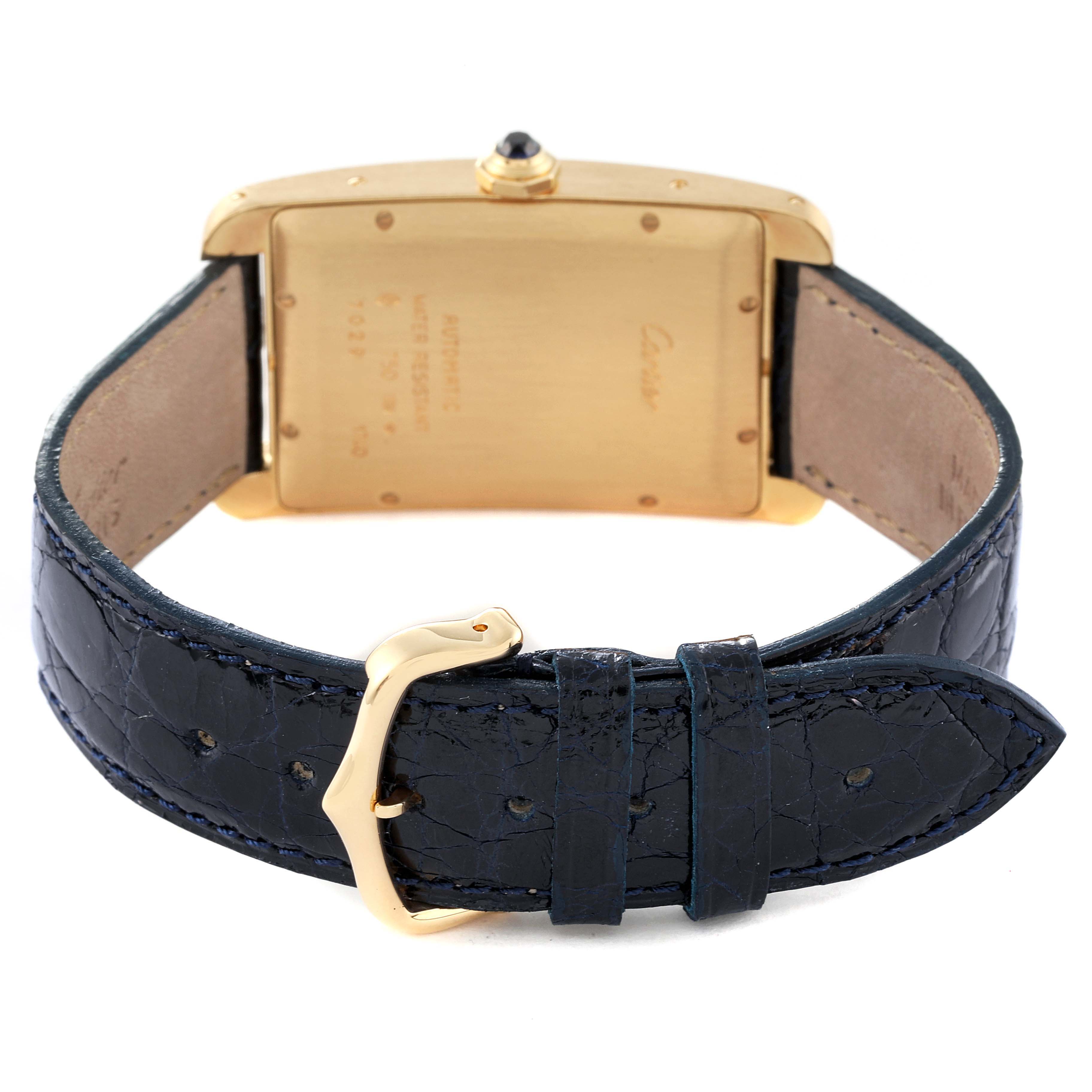 The image shows the back view of the Cartier Tank Americaine W2603156 Men's Yellow Gold Silver Dial W2603156 Men's Yellow Gold Silver Dial watch, highlighting its gold case and black leather strap with a buckle.