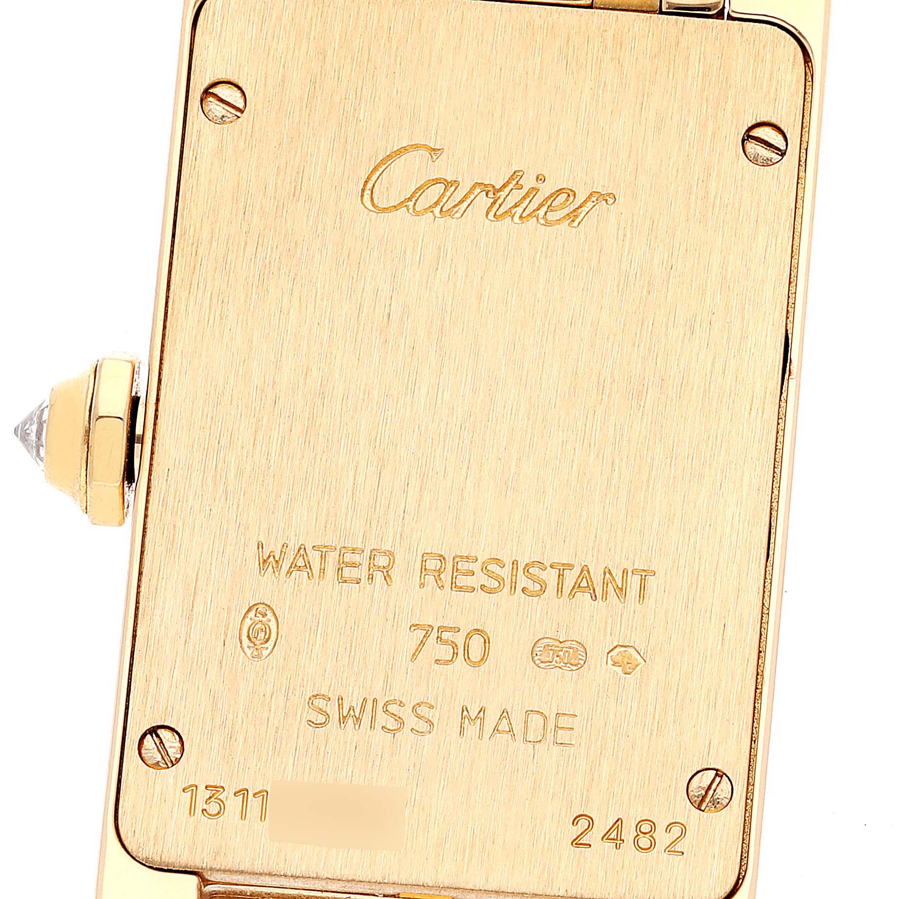 This is the back view of a Cartier Tank Americaine WB7072K2 Women's Yellow Gold Silver Dial WB7072K2 Women's Yellow Gold Silver Dial model watch, showing its inscriptions and water resistance information.