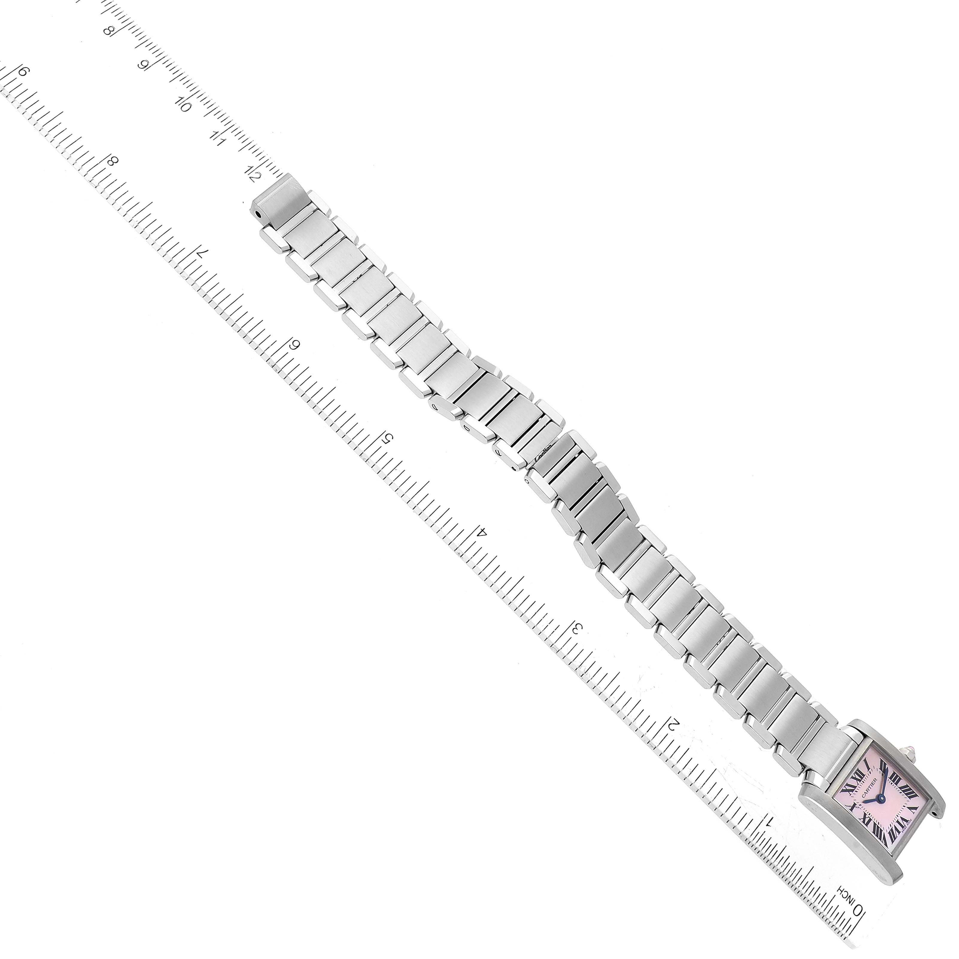 The Cartier Tank Francaise W51028Q3 Women's Stainless Steel Mother of Pearl Dial W51028Q3 Women's Stainless Steel Mother of Pearl Dial watch is shown from a top-down angle, displaying its bracelet and watch face next to a ruler.