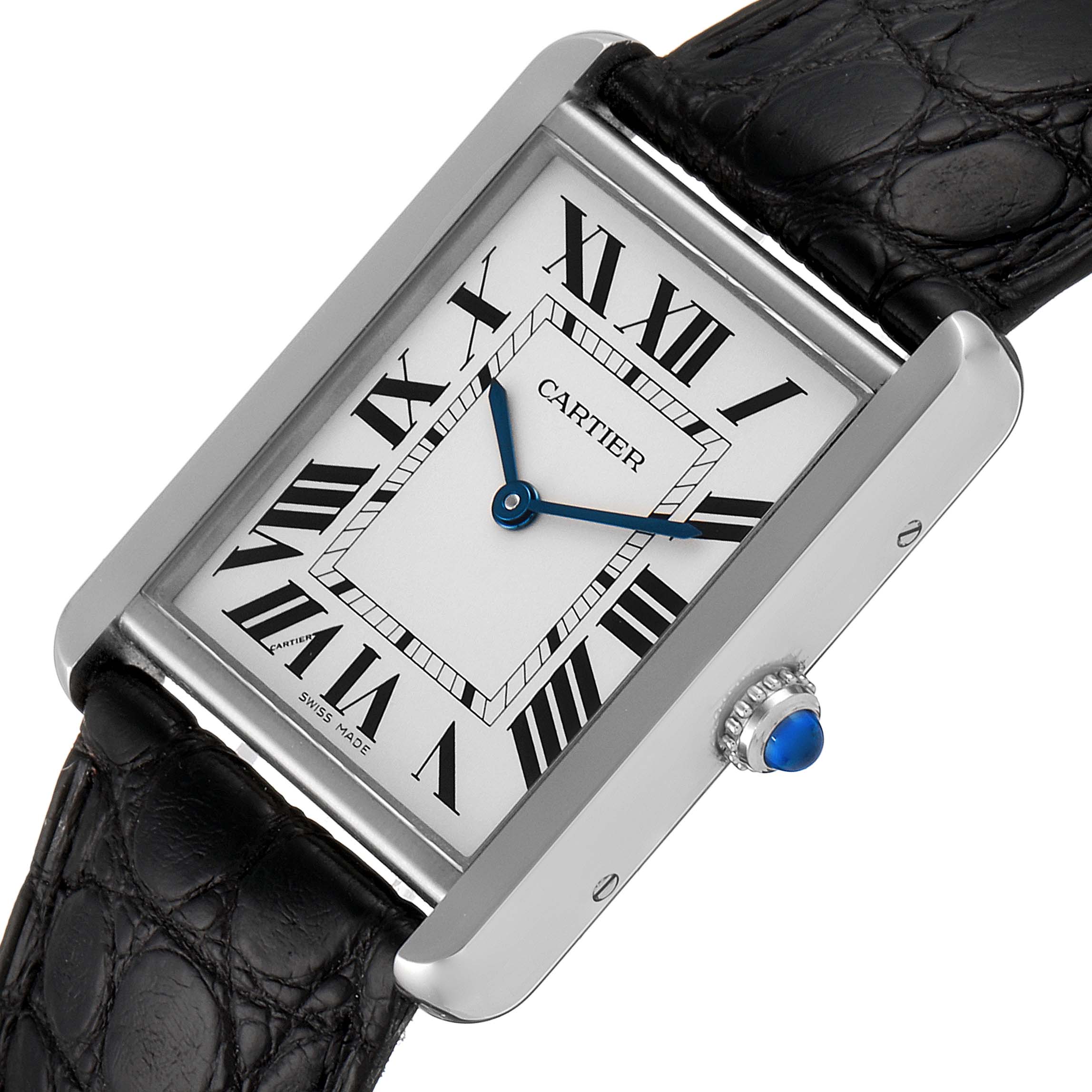 The Cartier Tank Solo W1018355 Men's Stainless Steel Silver Dial W1018355 Men's Stainless Steel Silver Dial watch is shown at an angle revealing its rectangular face, Roman numerals, blue hands, and a black leather strap.