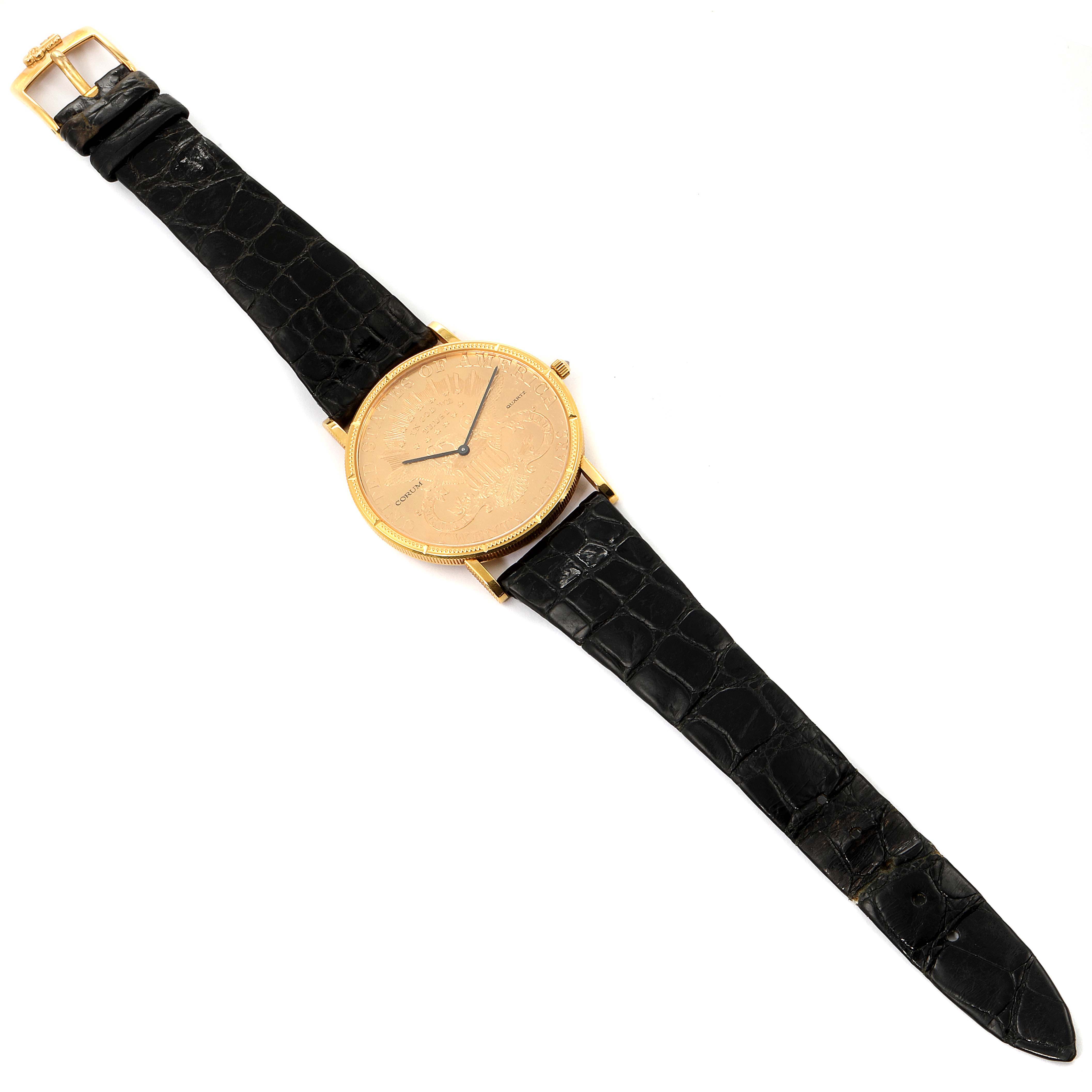 This image shows a Corum Coin Watch  Men's Yellow Gold Black Dial  Men's Yellow Gold Black Dial model from a top-down angle, displaying the entire watch with a black leather strap and gold face.