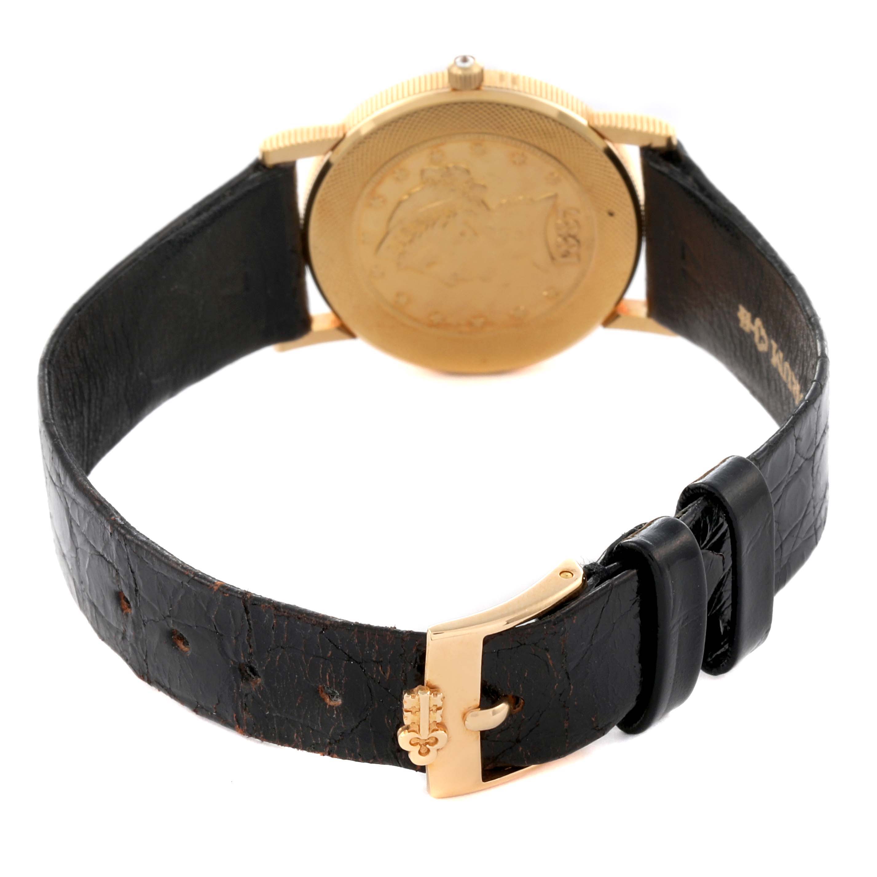 The image shows the back of the Corum 1887 Women's Yellow Gold Champagne Dial 1887 Women's Yellow Gold Champagne Dial Yellow Gold 5 Dollars Coin Diamond Ladies Watch, highlighting the strap and buckle.