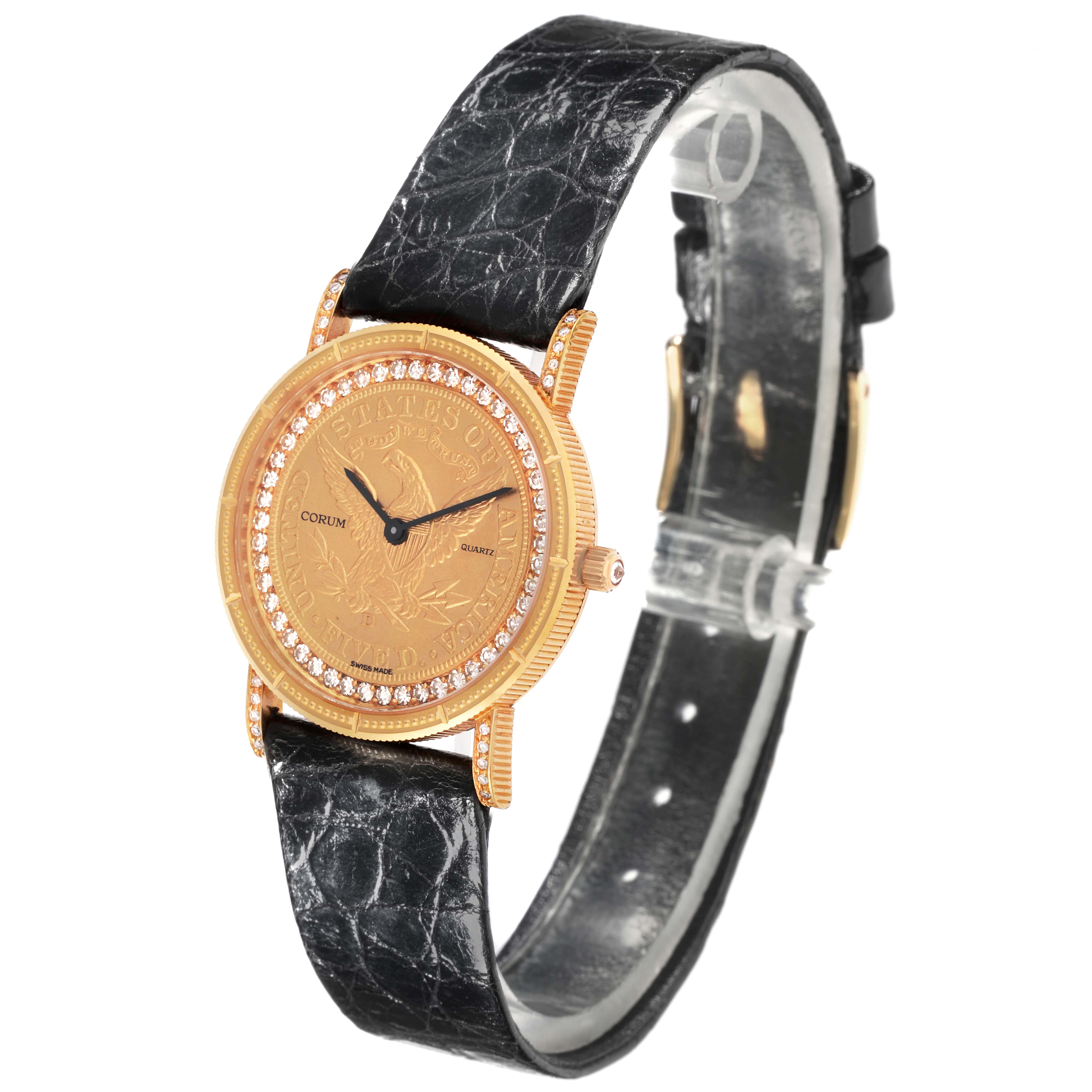 The Corum 1887 Women's Yellow Gold Champagne Dial 1887 Women's Yellow Gold Champagne Dial Yellow Gold 5 Dollars Coin Ladies Watch is shown at an angle displaying the gold coin face, diamond bezel, and black strap.
