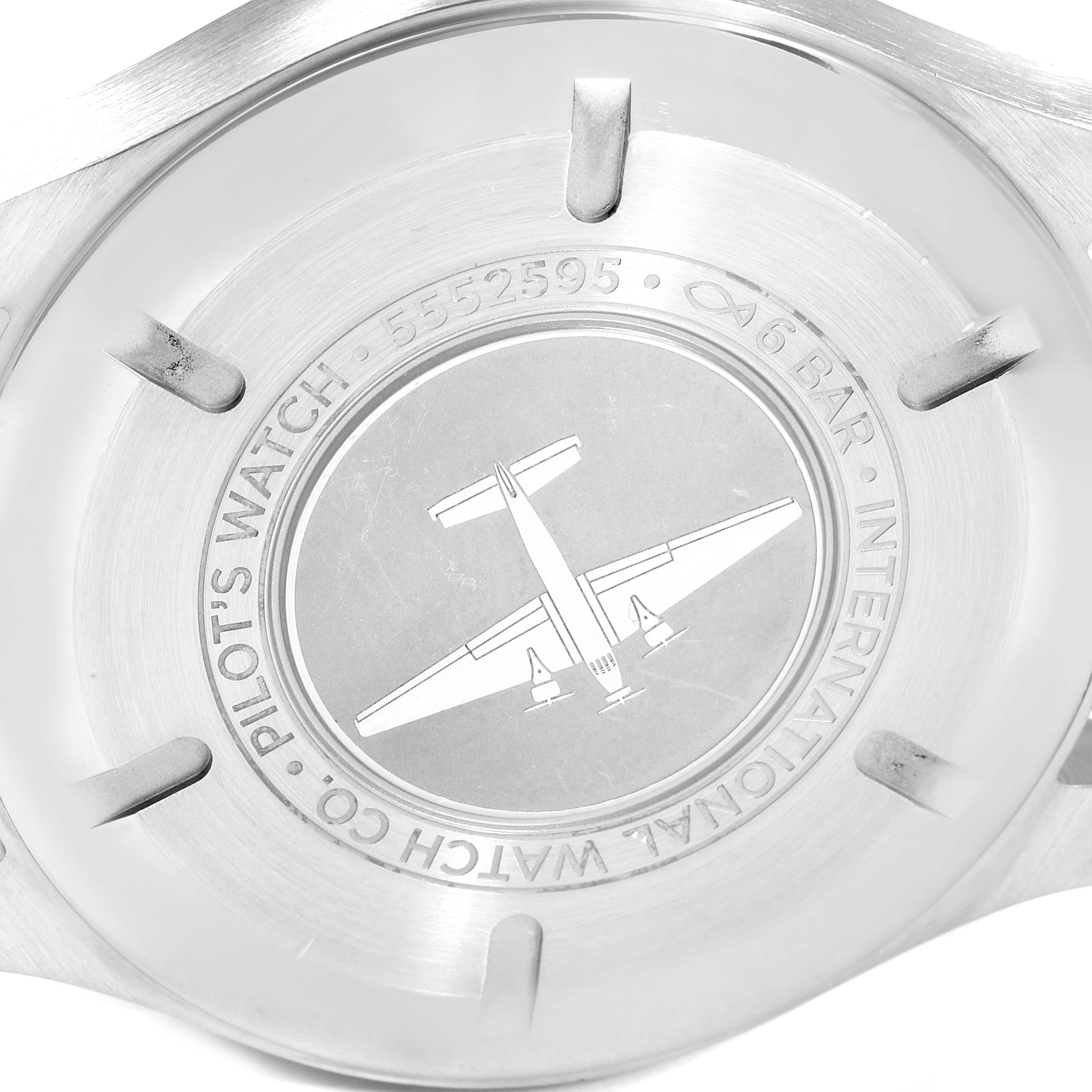 This image shows the back case of an IWC Pilot IW327001 Men
s Stainless Steel Black Dial IW327001 Men
s Stainless Steel Black Dial model watch, featuring an engraved airplane and inscriptions.