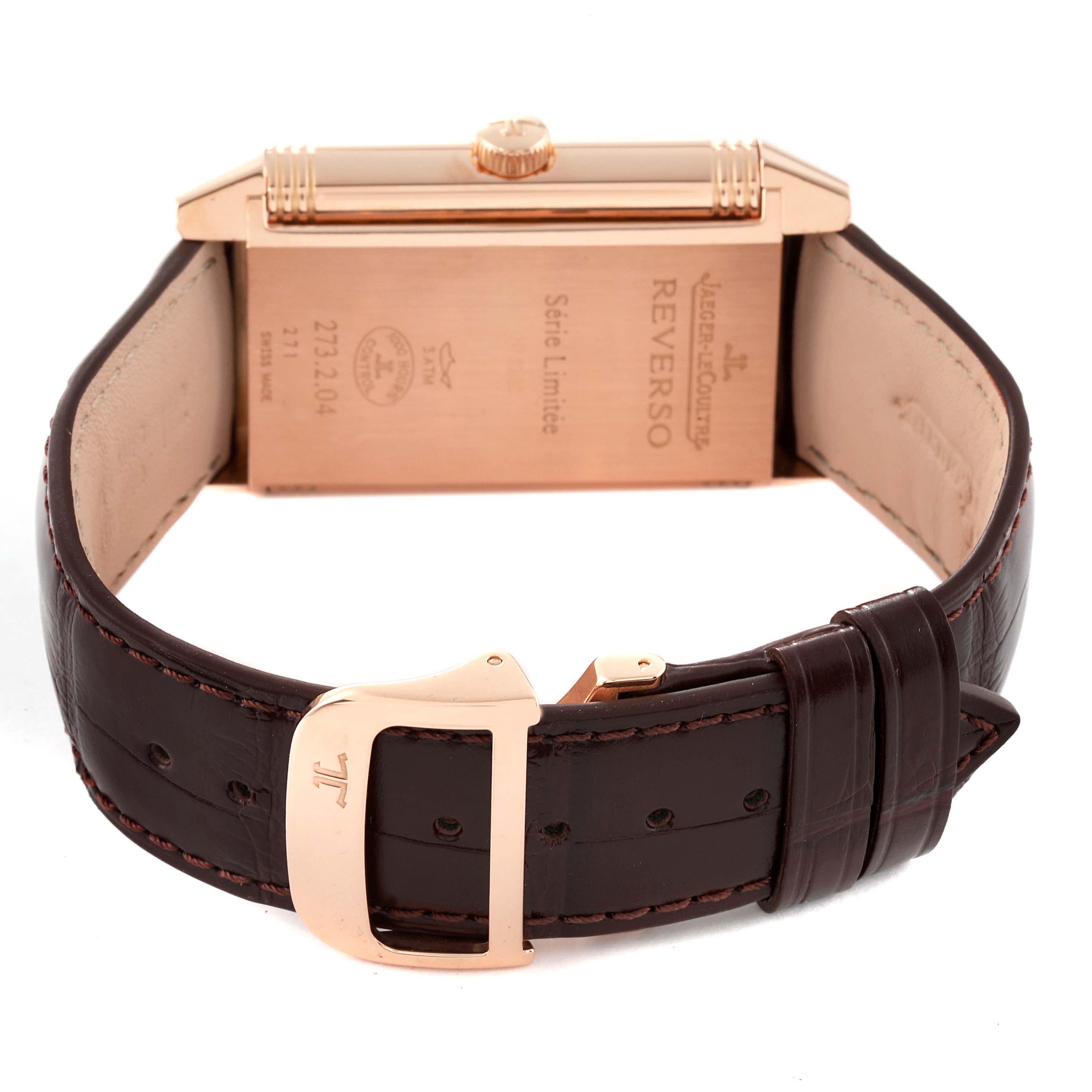 The image shows the back and side view of the Reverso model by Jaeger LeCoultre, highlighting its leather strap and clasp.