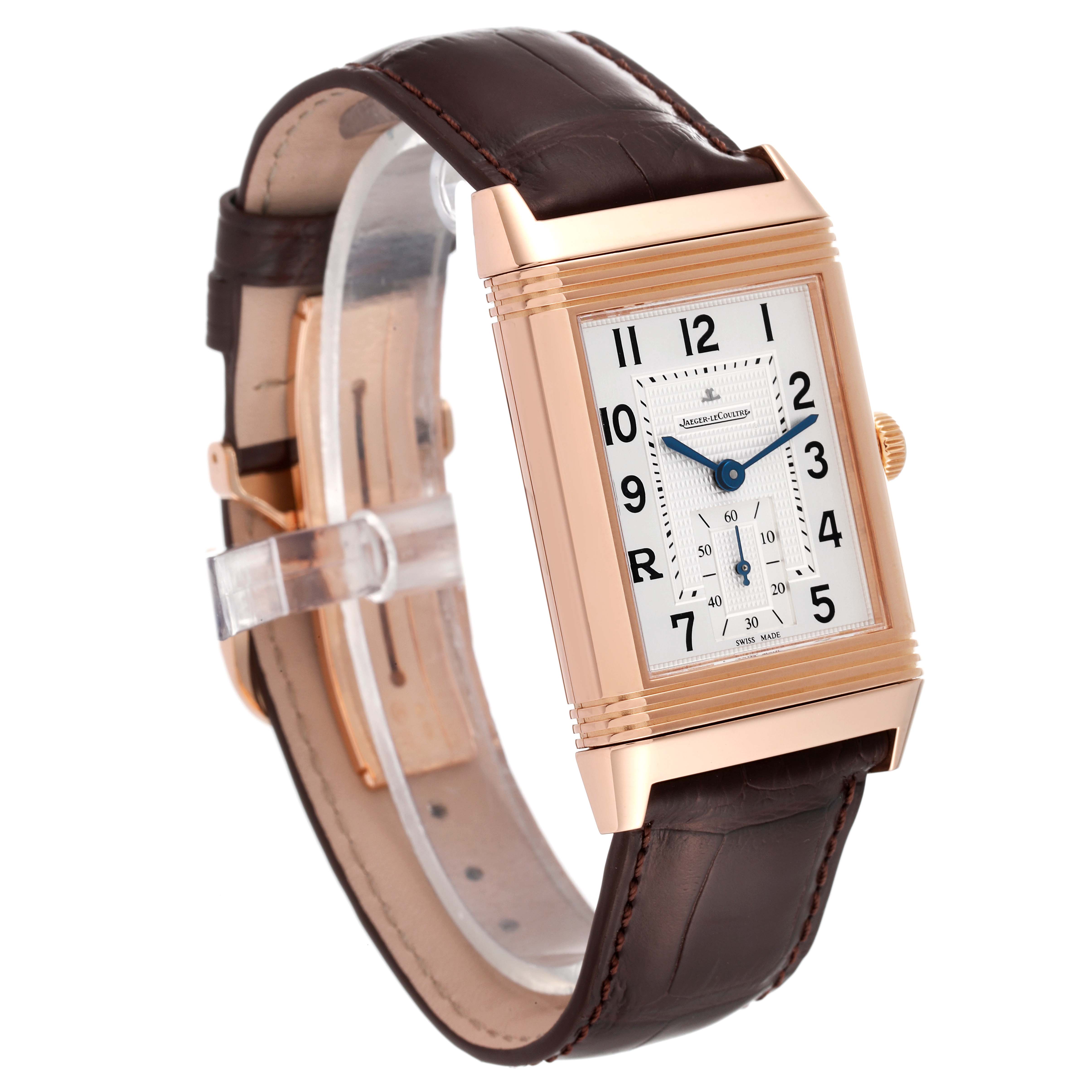 This picture shows a Jaeger-LeCoultre Reverso watch, including its rectangular face, leather strap, and side crown, taken at a slight angle.