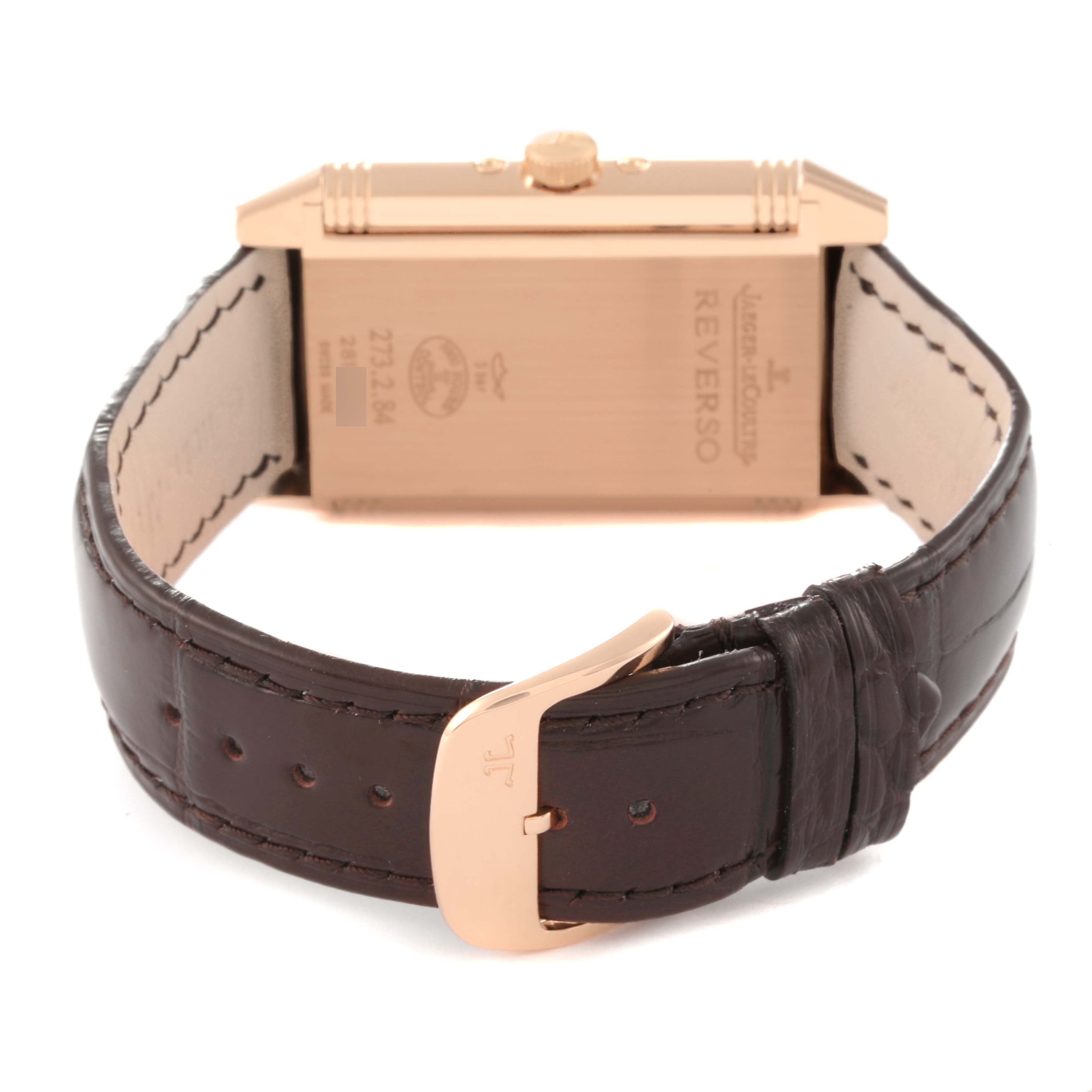 The image shows the back angle of the Jaeger LeCoultre Reverso Q3752520 Men's Rose Gold Silver Dial Q3752520 Men's Rose Gold Silver Dial watch, highlighting its case back, crown, and brown leather strap with a clasp.