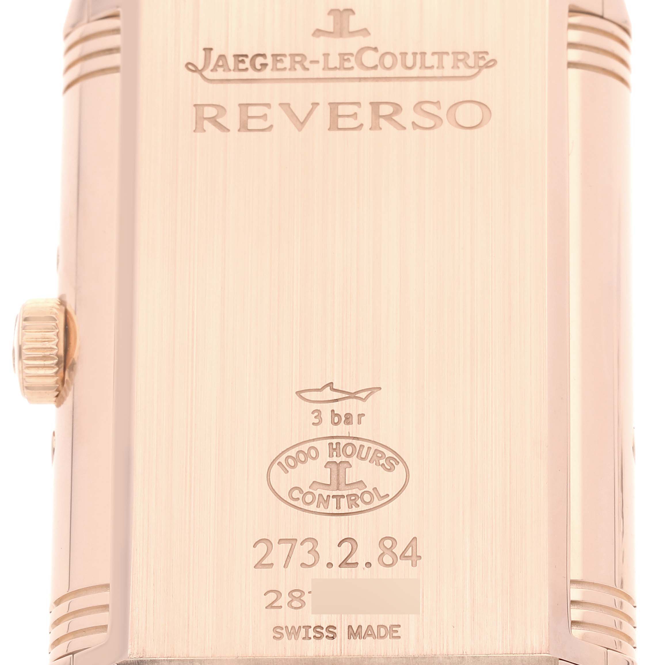 This image shows the back of the Jaeger-LeCoultre Reverso watch, highlighting the engravings and side crown.