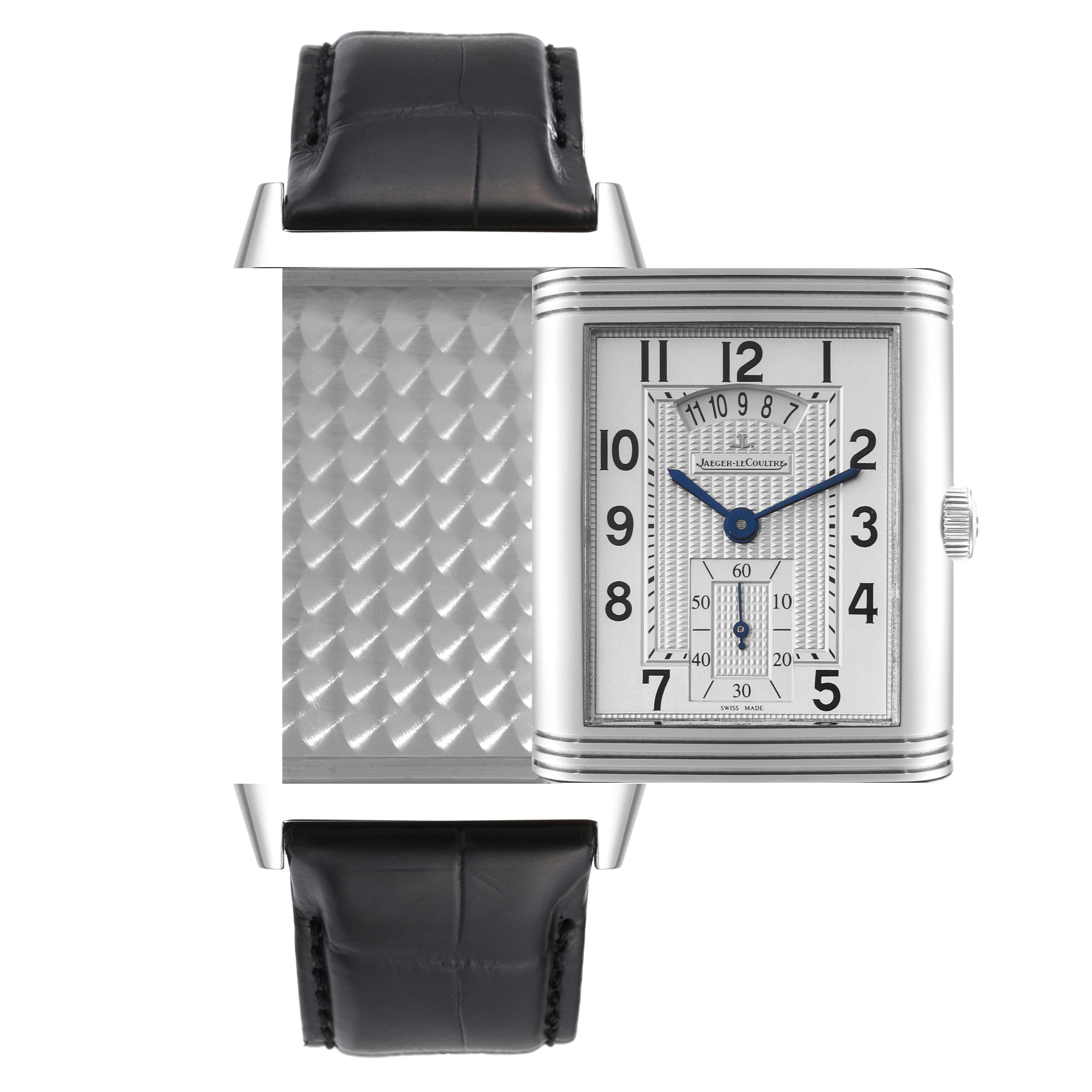 The image shows a frontal view of a Jaeger-LeCoultre Reverso watch with its case partially rotated, revealing its detailed back.