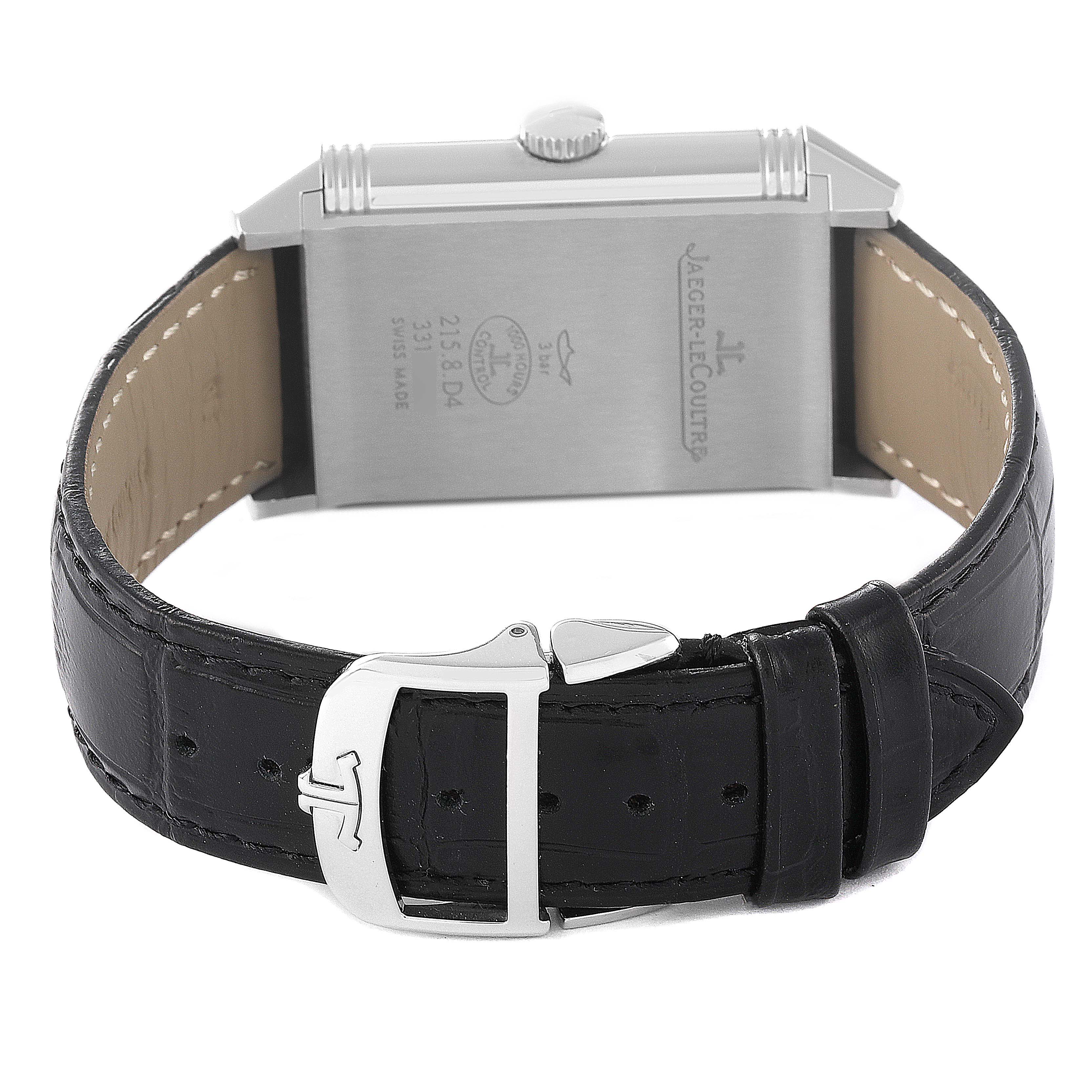 The image shows the back and clasp of the Jaeger LeCoultre Reverso Q3848420 Men's Stainless Steel Silver Dial Q3848420 Men's Stainless Steel Silver Dial watch, showcasing its leather strap and engraved details.