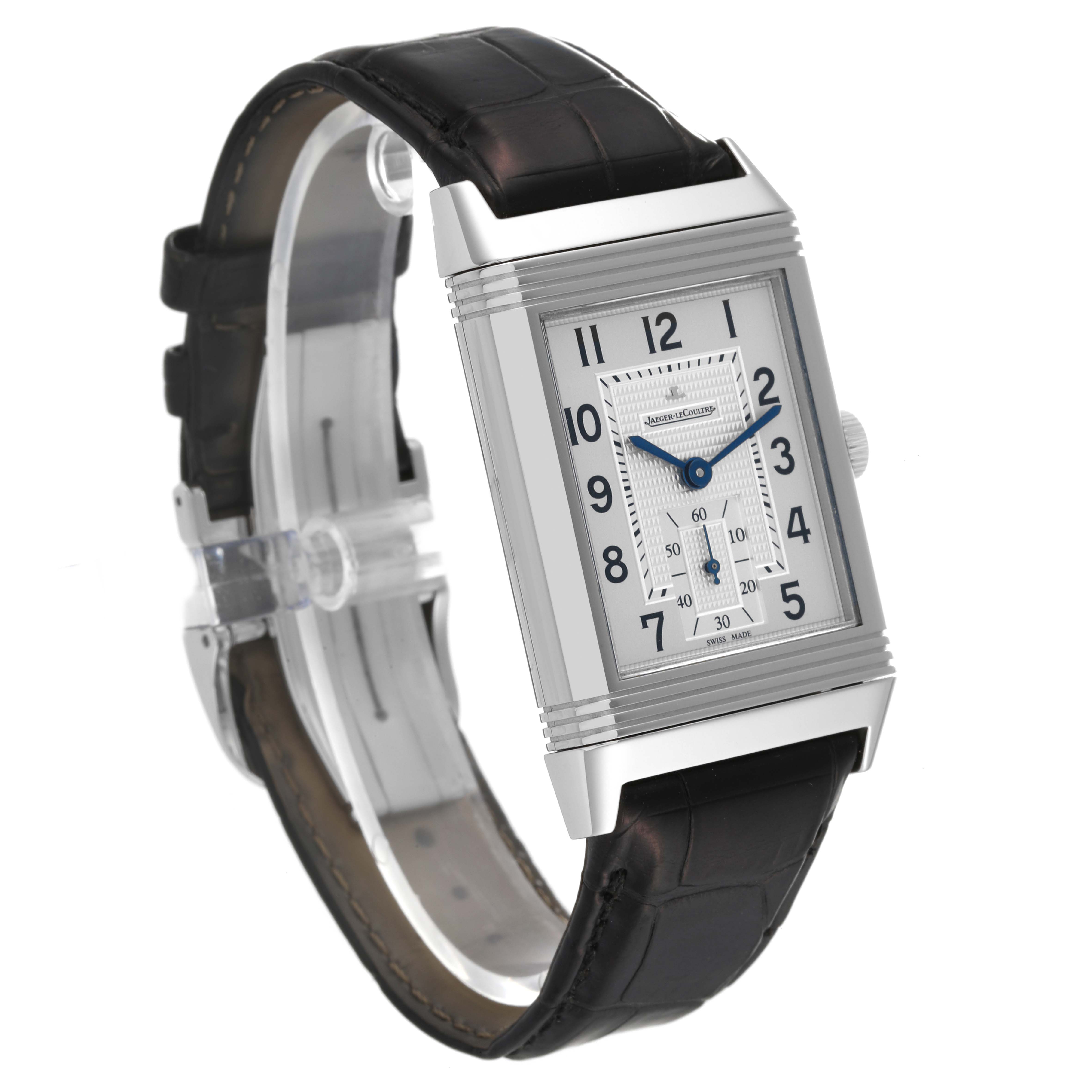 The Jaeger-LeCoultre Reverso watch is shown at a 3/4 angle, highlighting the dial, case, and leather strap.