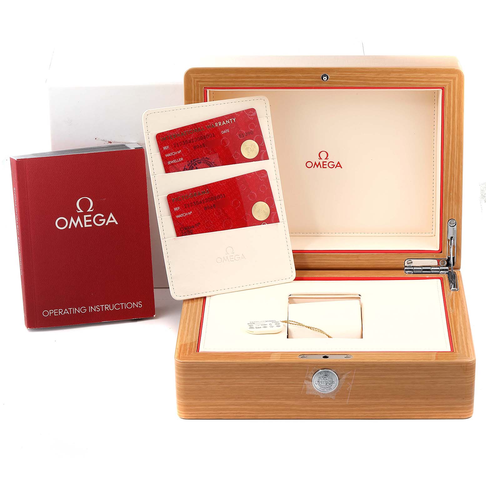 This image shows the Omega Seamaster 212.30.41.20.03.001 Men's Stainless Steel Blue Dial 212.30.41.20.03.001 Men's Stainless Steel Blue Dial watch box, operating instructions booklet, warranty card holder, and a tag.