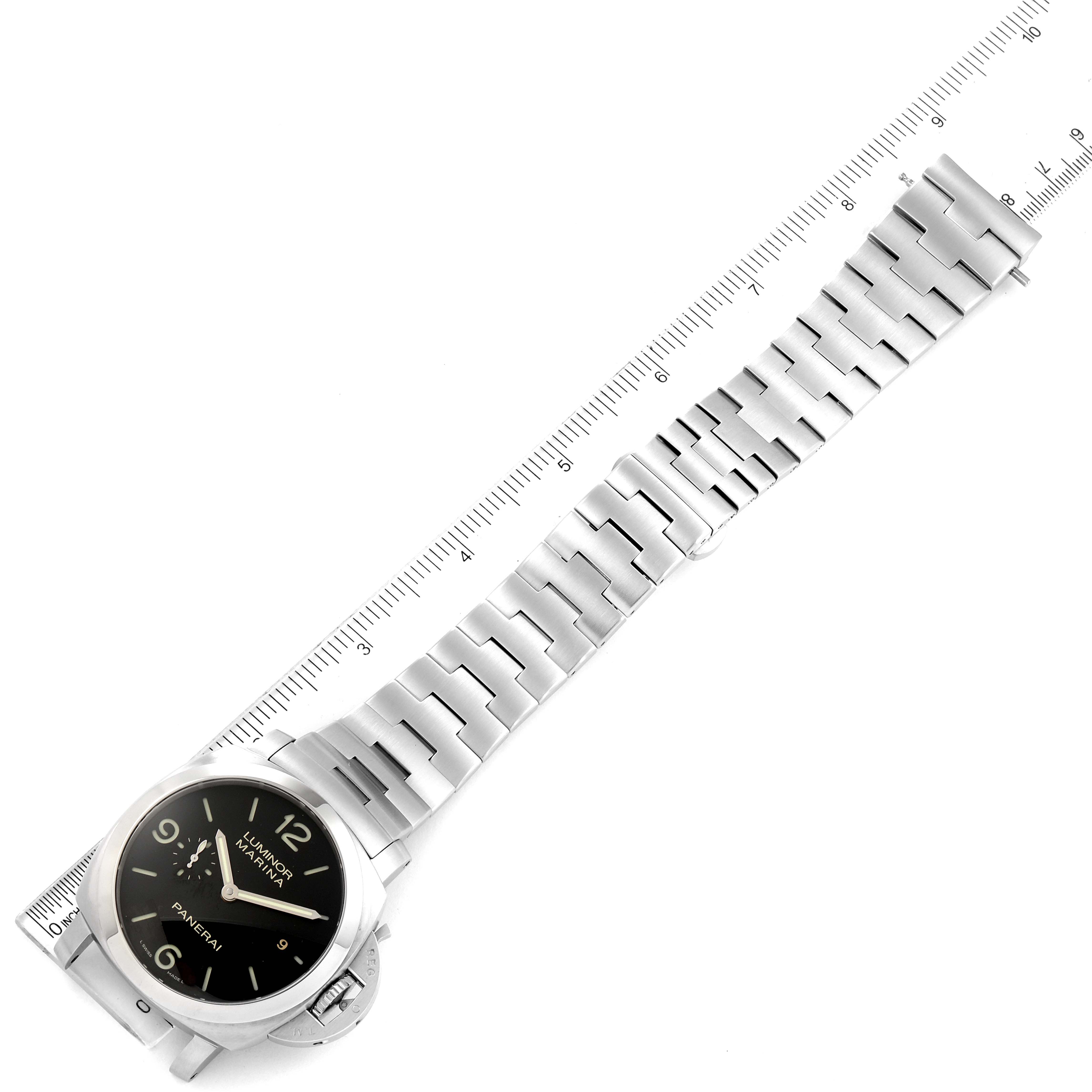 The watch is a Panerai Luminor PAM00328 Men's Stainless Steel Black Dial PAM00328 Men's Stainless Steel Black Dial model, shown from a top view with a metal strap laid along a ruler.