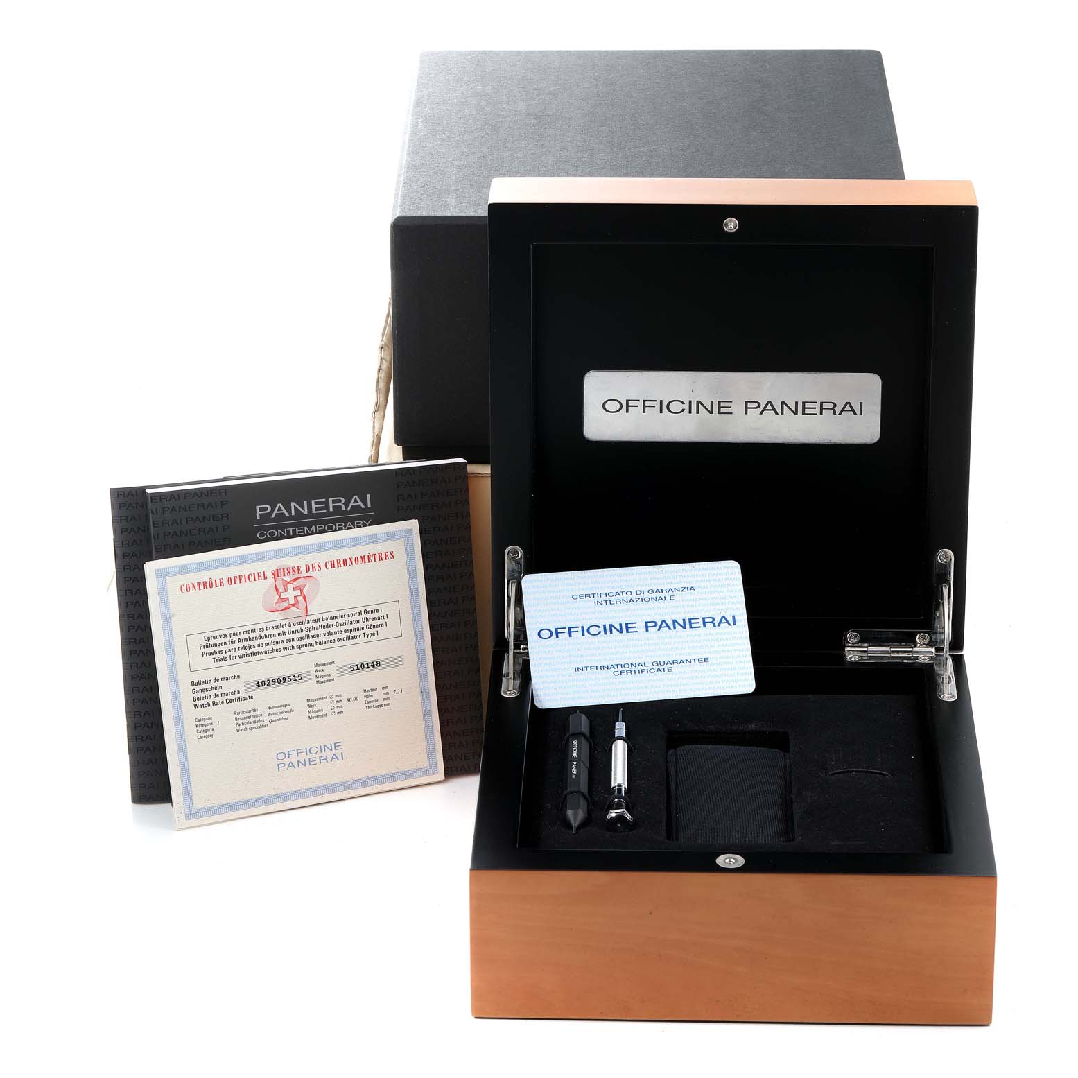 This image shows the packaging and accessories for a Panerai Luminor PAM00104 Men
s Stainless Steel Black Dial PAM00104 Men
s Stainless Steel Black Dial watch, including the box, warranty cards, and tools.