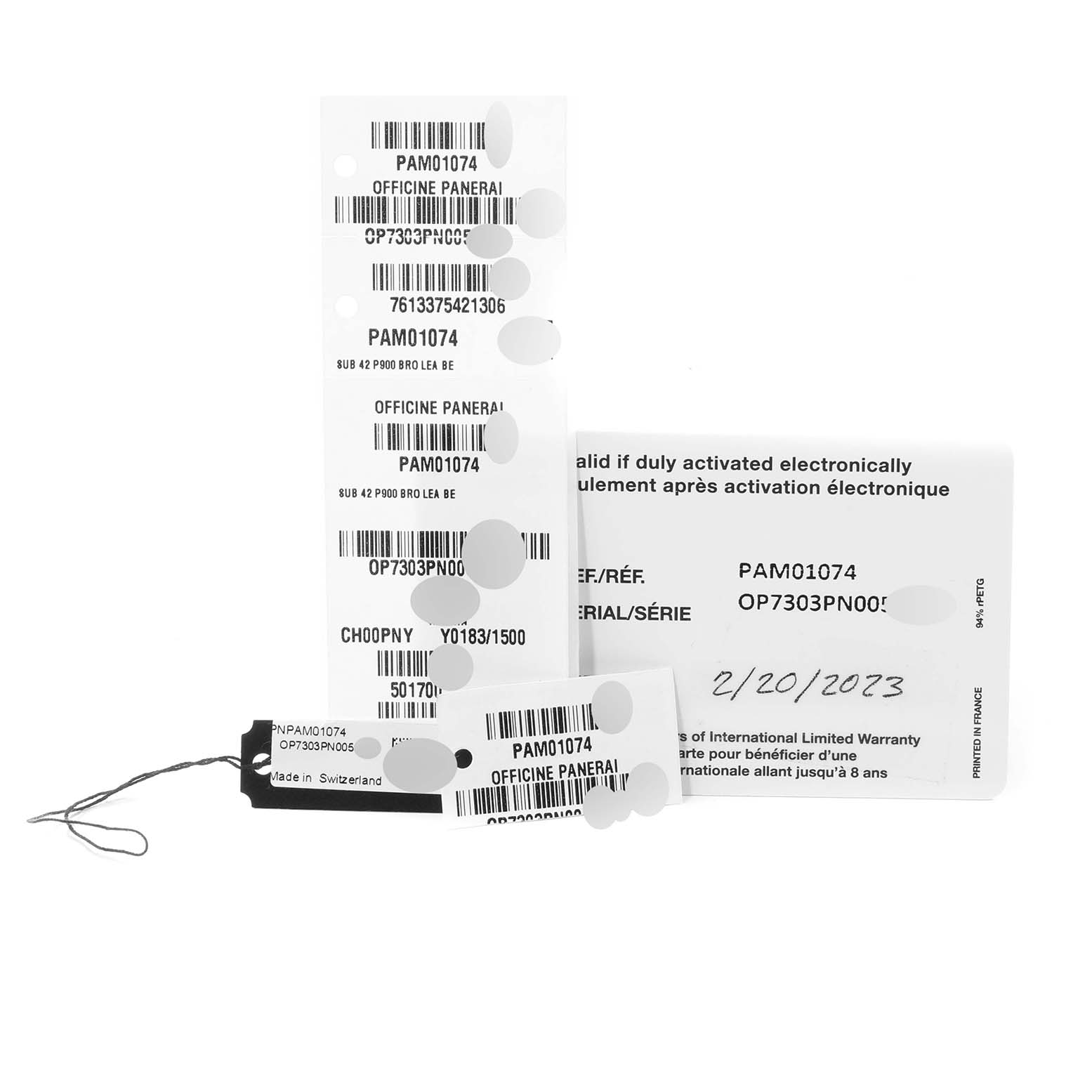 The image shows tags and warranty cards for a Panerai Submersible PAM01074 Men's Bronze Blue Dial PAM01074 Men's Bronze Blue Dial model PAM01074.