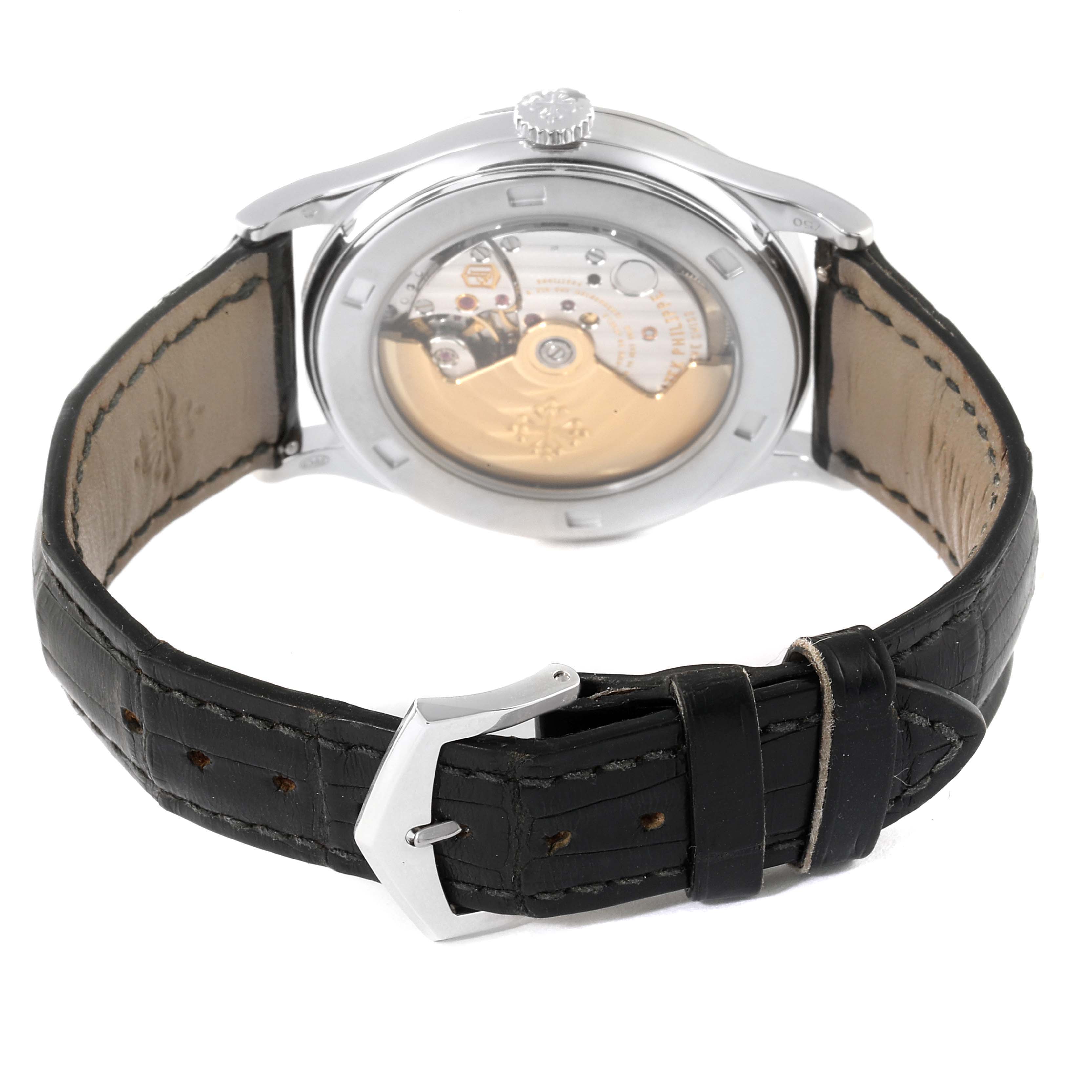 The image shows the back view of the Patek Philippe Calatrava 5297G Men's White Gold Black Dial 5297G Men's White Gold Black Dial watch, displaying its open case back and black leather strap.
